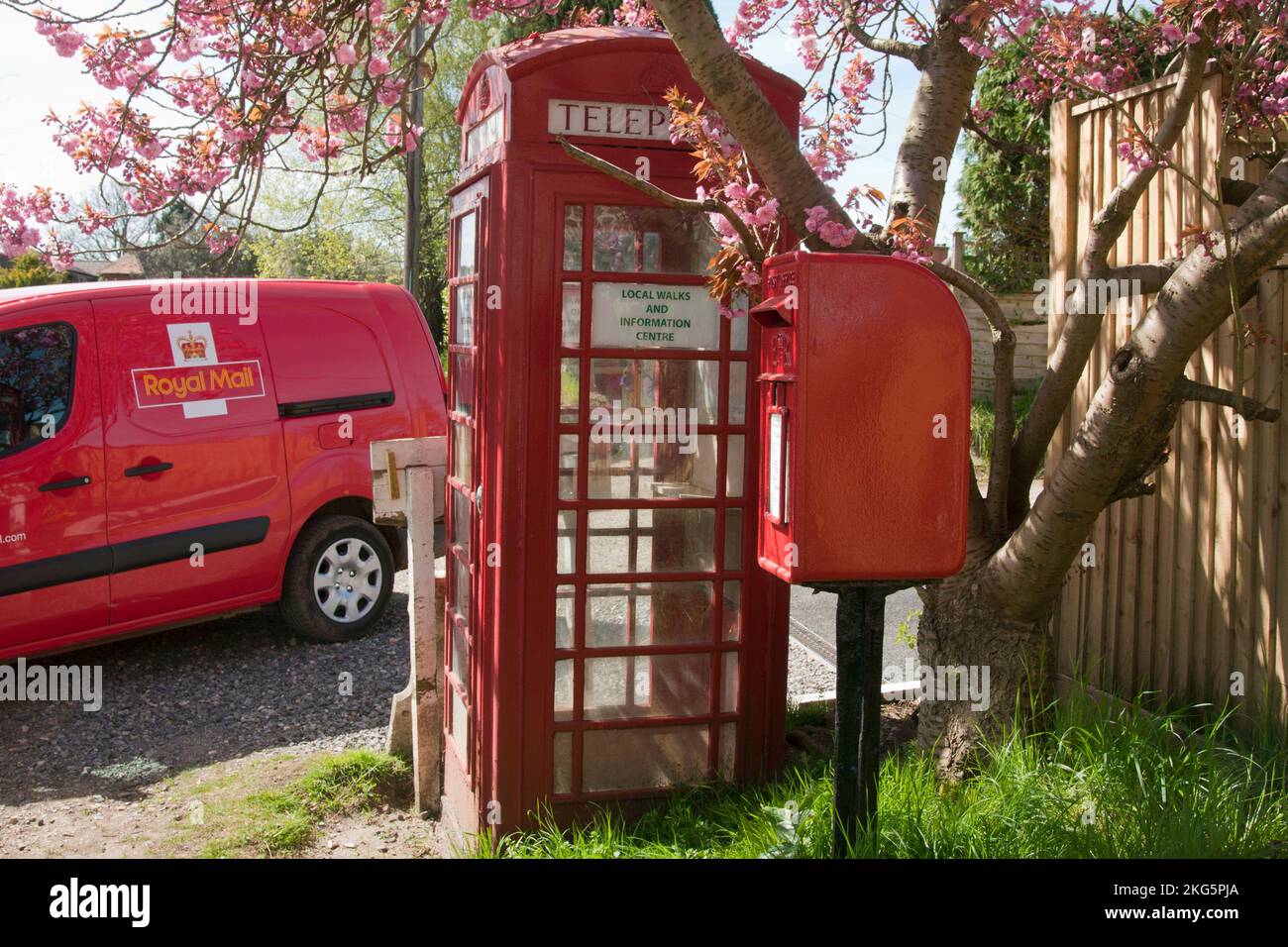 Trio of english traditional red telephone box (redundant), royal mail van and lamp letterbox in Stedham, Midhurst, West Sussex, England Stock Photo