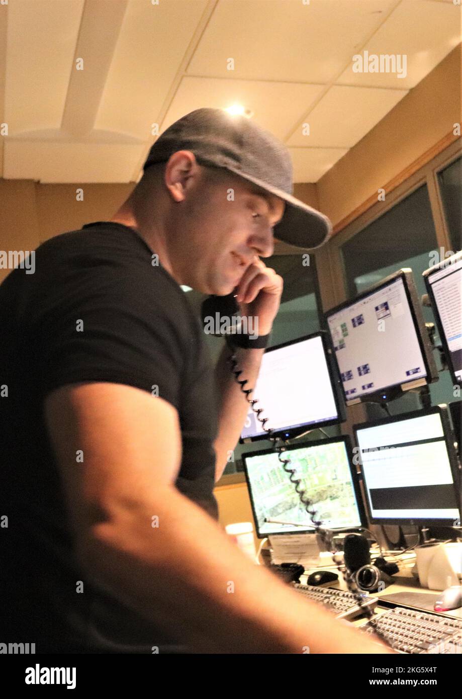 Aaron Demarte, public safety dispatcher with the Fort McCoy Directorate of Emergency Services (DES) 911 Communications/Security Center, processes a request Oct. 5, 2022, in the center at Fort McCoy, Wis. The center, also referred to as DES Dispatch Center at the installation, maintains its coverage and support 24 hours a day, seven days a week. Dispatchers use a variety of emergency communications and electronic equipment to complete their duties. This includes equipment that is commonly used by police, fire, ambulance, rescue, or hazardous materials units. Dispatchers can also provide emergen Stock Photo