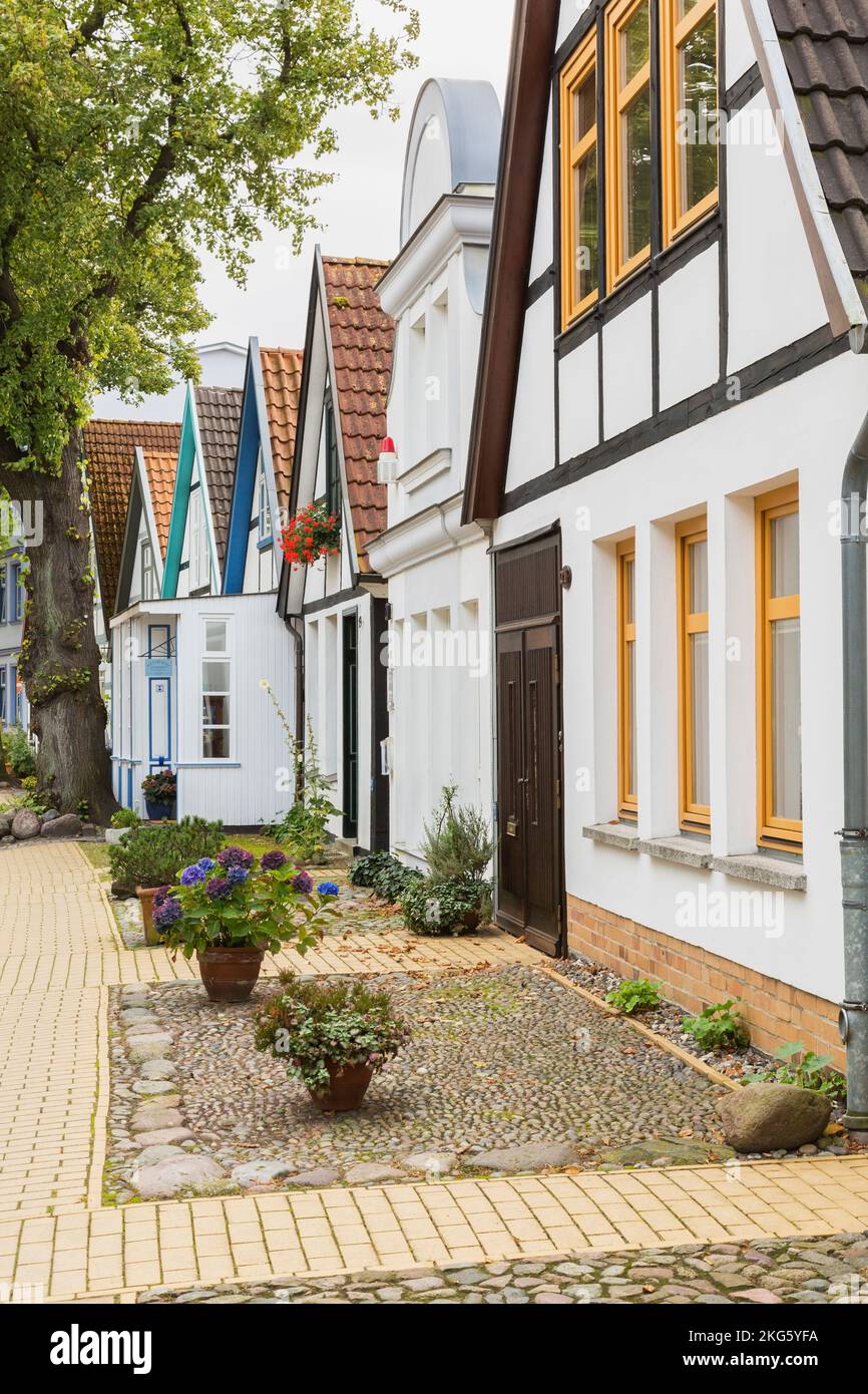 Residential street with colourful house facades and terracotta rooftops, Warnemunde seaside resort in the district of Rostock, Germany. Stock Photo