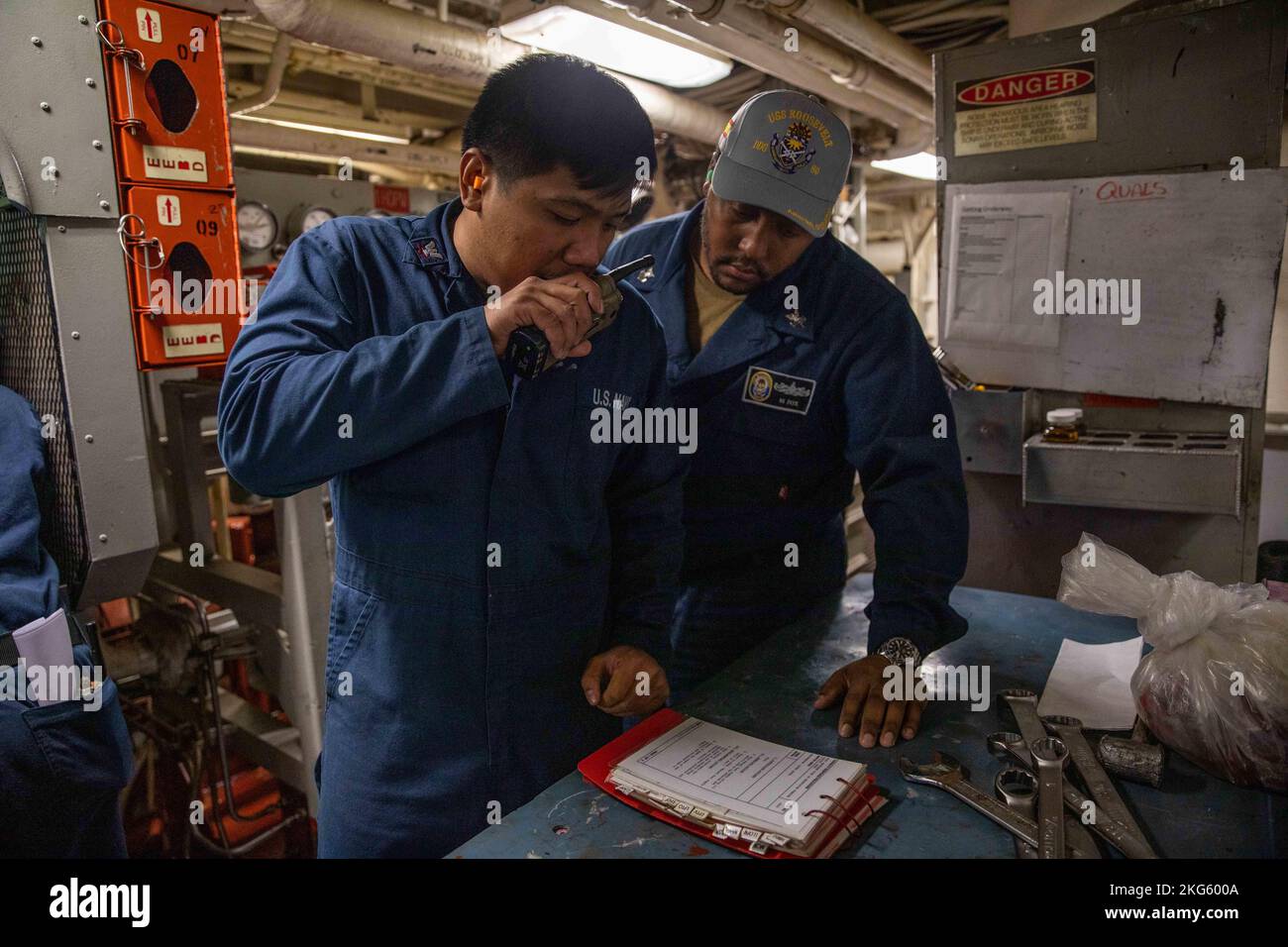 THE MINCH (Oct. 6, 2022) Gas Turbine Systems Technician (Mechanical) 3rd Class Reynante Imperial, left, communicates with central control station during an engineering drill in the engine room of the Arleigh Burke-class guided-missile destroyer USS Roosevelt (DDG 80), Oct. 6, 2022. Exercise Joint Warrior 22-2 is a U.K.-hosted, multilateral training exercise designed to provide NATO and allied forces with a unique multi-warfare environment to prepare for global operations. Roosevelt is on a scheduled deployment in the U.S. Naval Forces Europe area of operations, employed by U.S. Sixth Fleet to Stock Photo