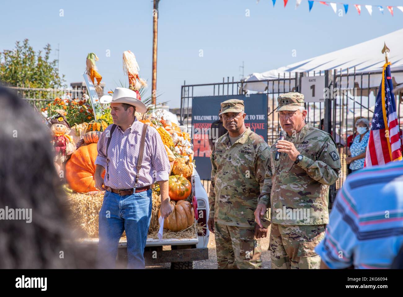 Commissioner Andy Gibson (right), Mississippi’s eighth Commissioner of Agriculture and Commerce, stands with Command Sgt. Maj. Silvester Tatum, senior enlisted leader of the Mississippi National Guard, and Maj. Gen. Janson D. Boyles, the adjutant general of Mississippi, while he speaks to a crowd outside of the Mississippi Fairgrounds in Jackson, Mississippi, Oct. 6, 2022. Members of the 41st Army Band, Mississippi Army National Guard, played the National Anthem at the Mississippi State Fair. (U.S. Army National Guard photos by Staff Sgt. Connie Jones) Stock Photo