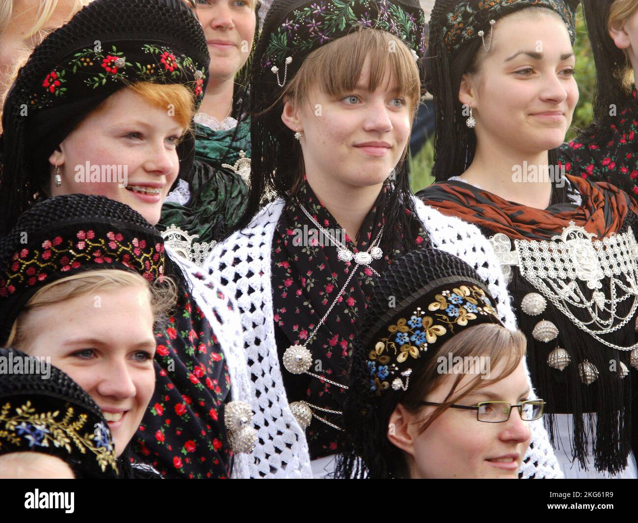 Faces of young girls in frisian costumes, close-up, during midsummer festival on Amrum, North Frisian Islands, Germany Stock Photo