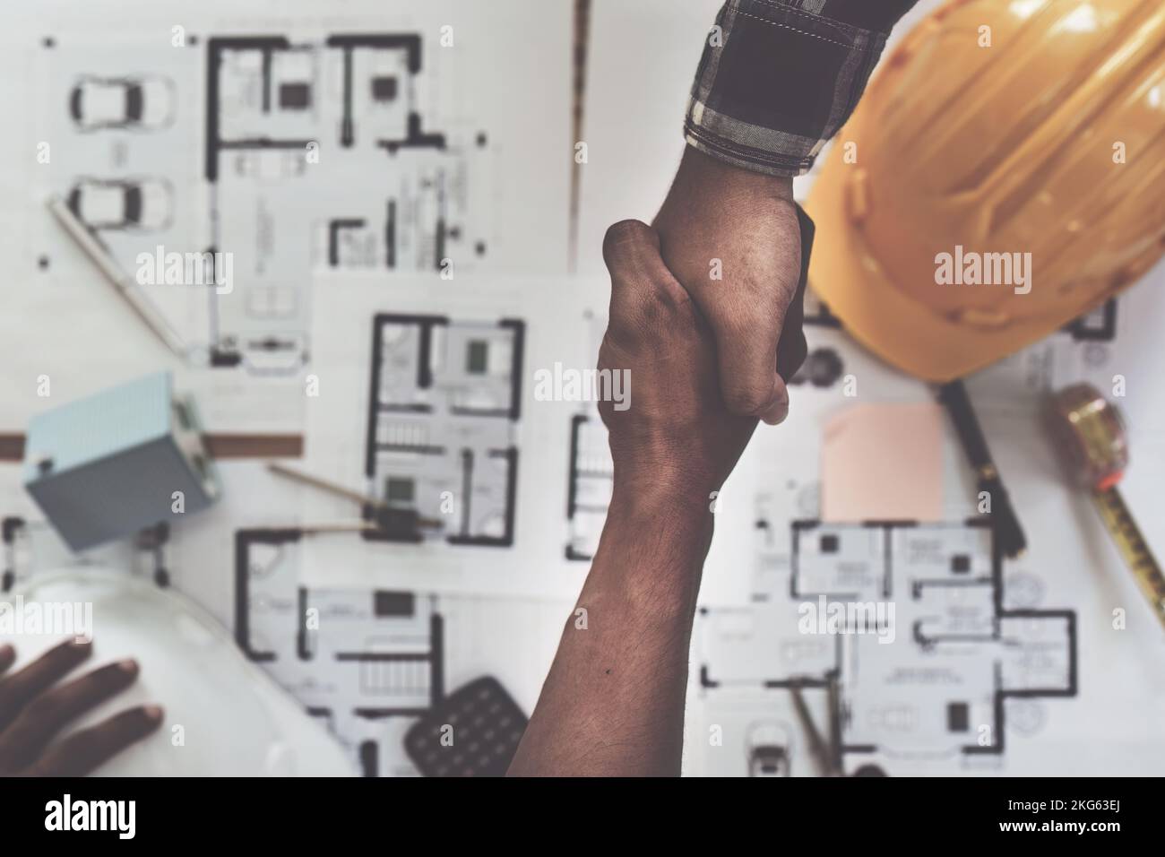 Architect and engineer construction workers shaking hands after finish an agreement in the