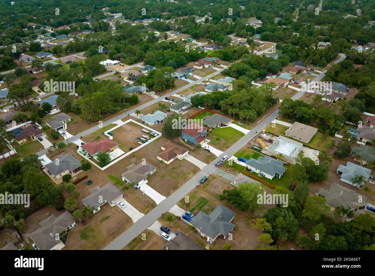Aerial landscape view of suburban private houses between green palm