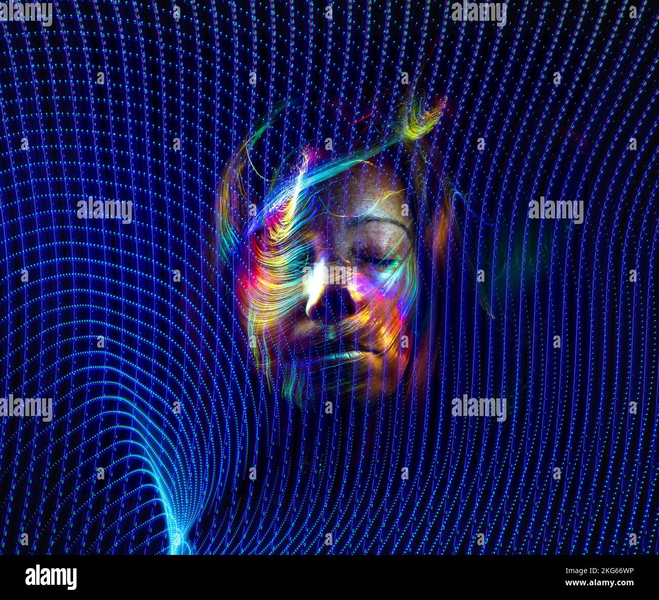 Face of a woman with colored lights superimposed on blue lines ...