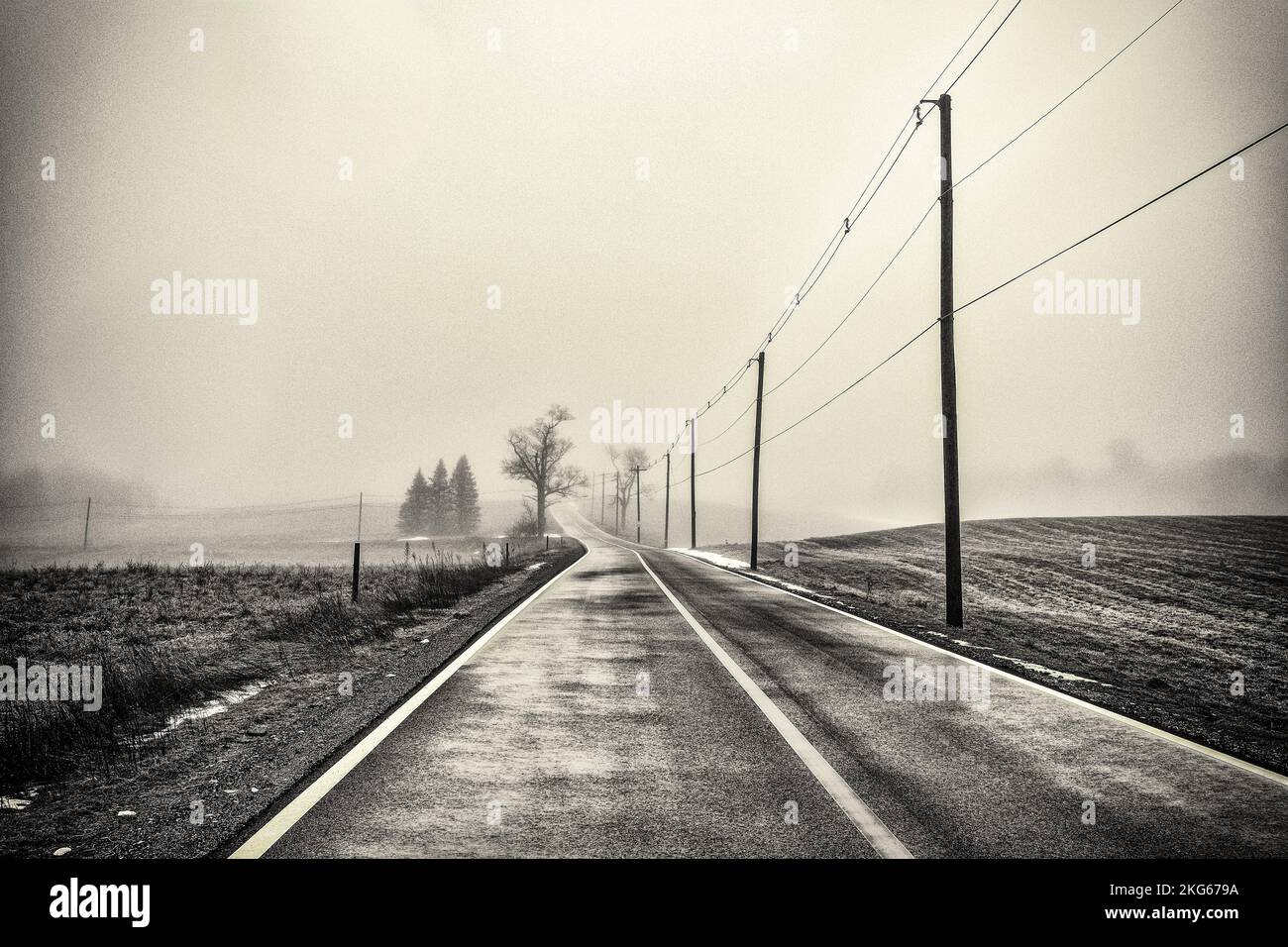 A lonely foggy road in the rural town of Templeton, Massachusetts Stock Photo