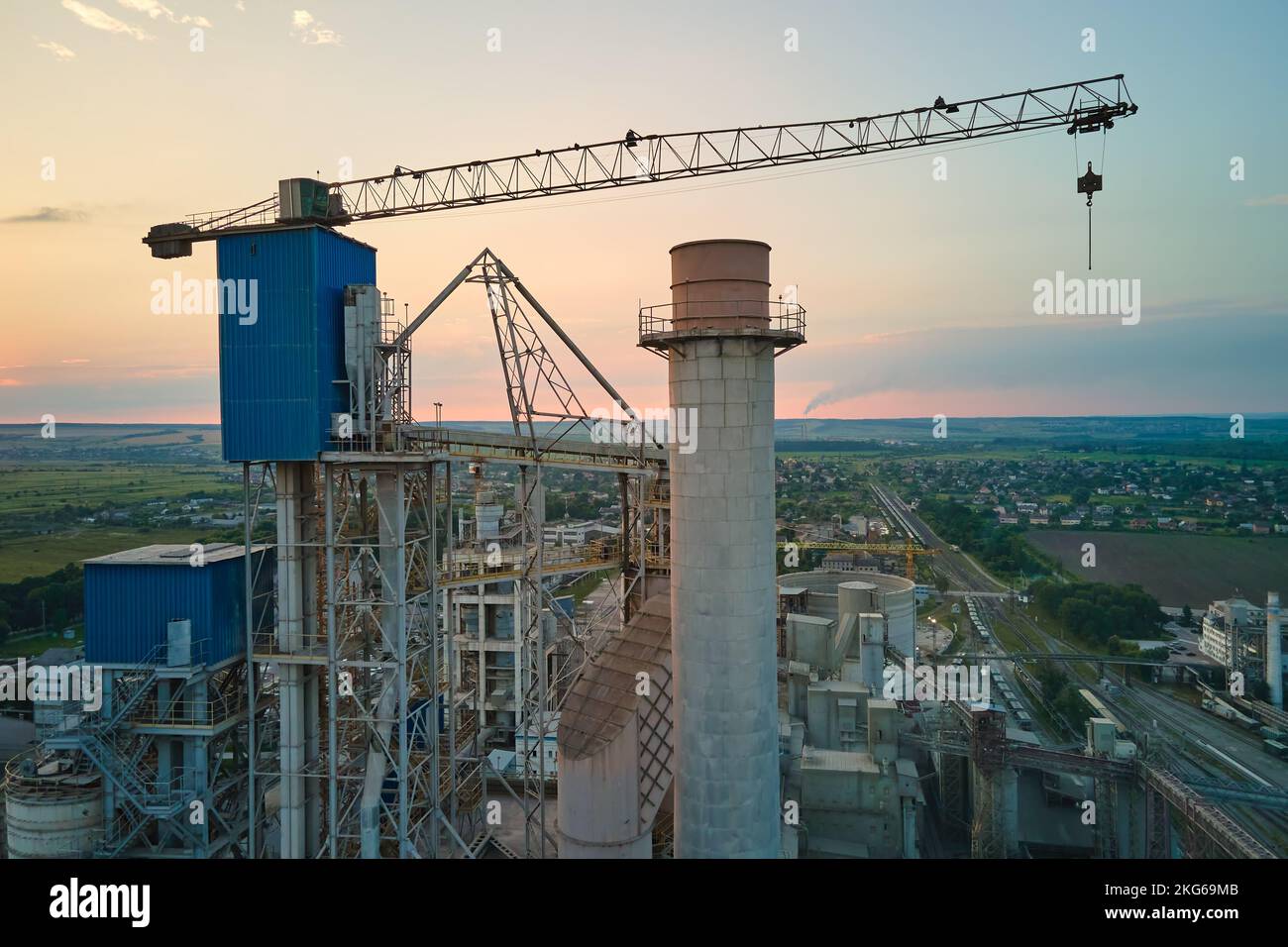 Cement plant with high factory structure and tower cranes at industrial