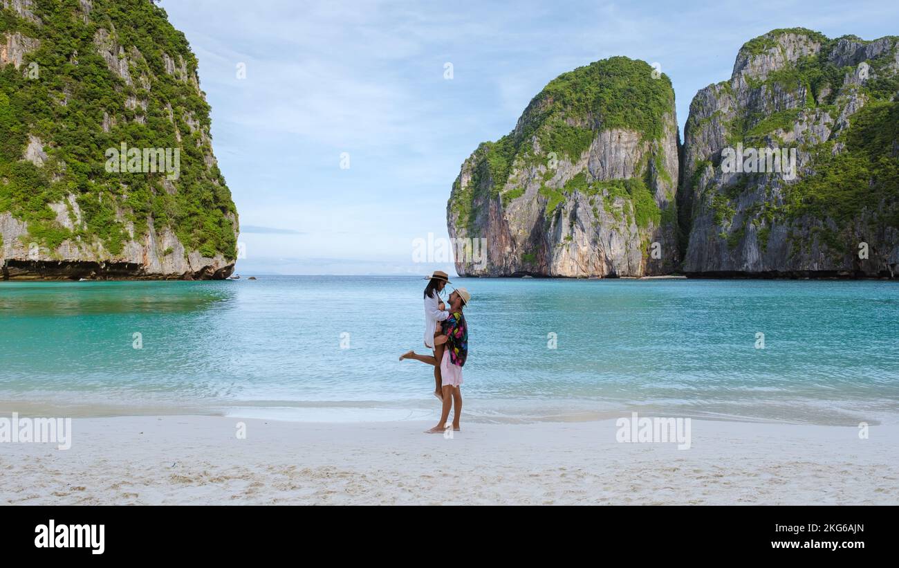 Couple hugging on the beach, Thai women and caucasian men walk on the