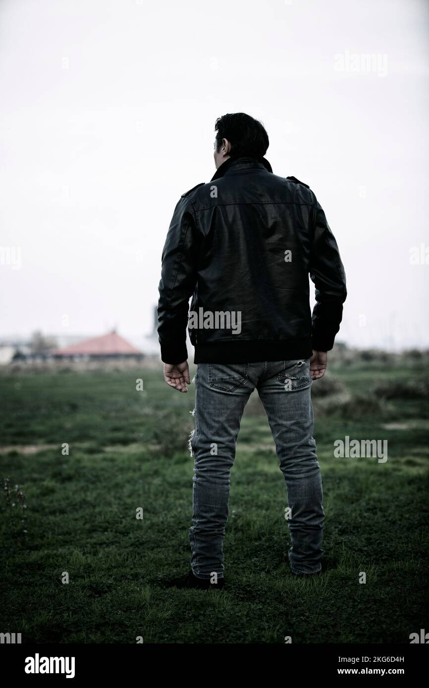 Man in leather jacket standing hi-res stock photography and images - Alamy