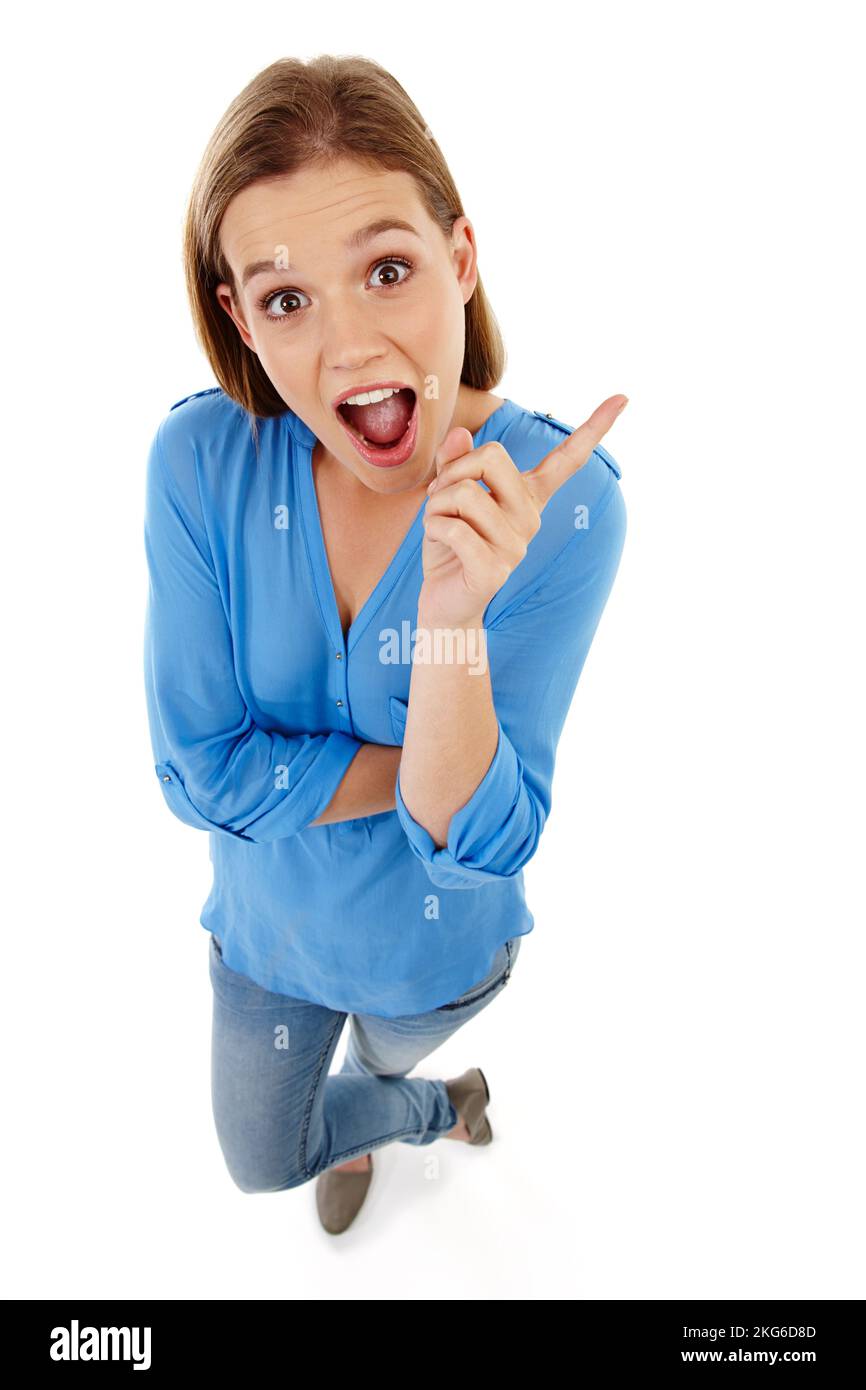 Got to have it. High-angle view of a pretty teenage girl pointing at something and looking surprised. Stock Photo