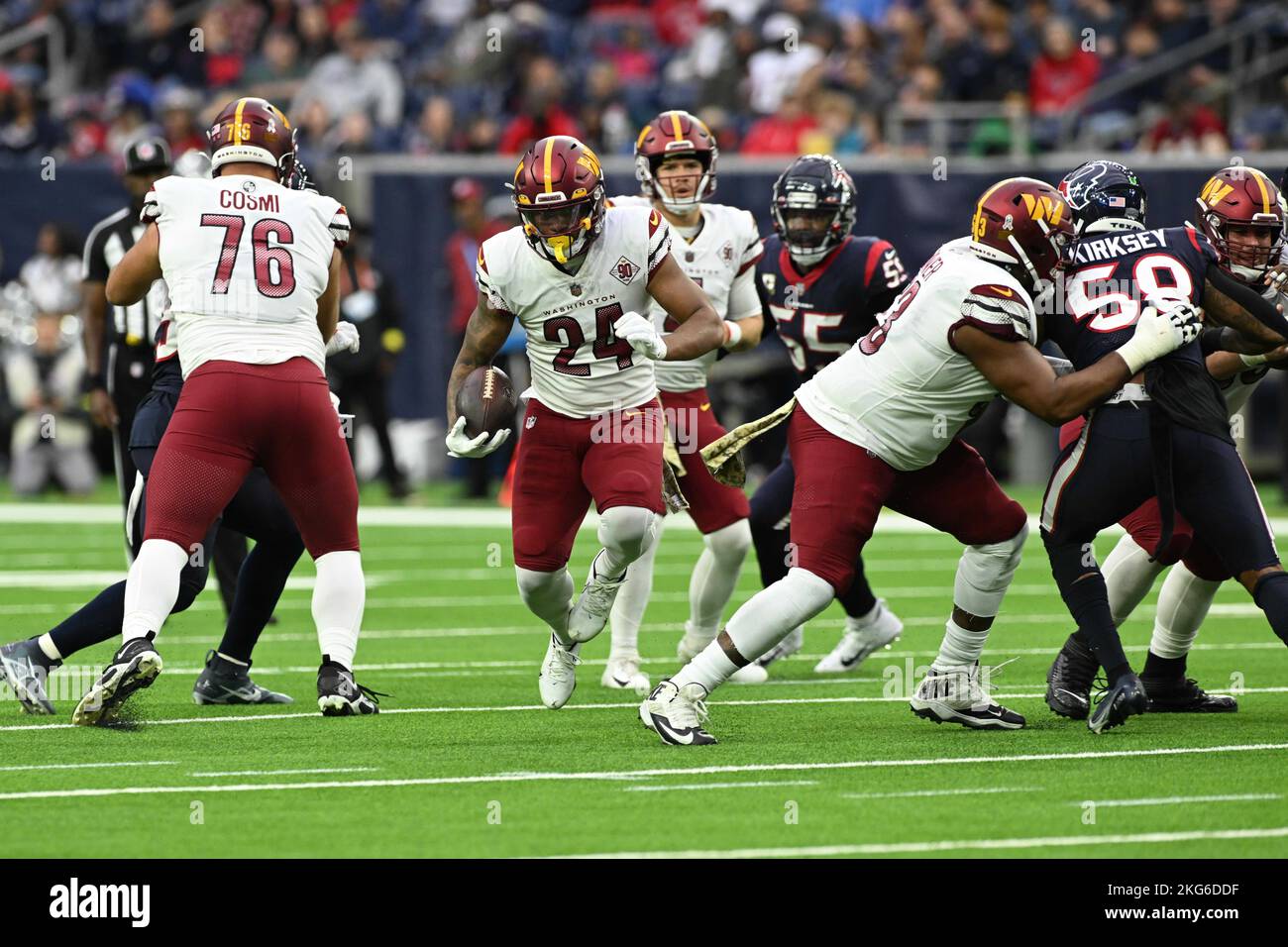 Washington Commanders running back Antonio Gibson (24) hits the hole