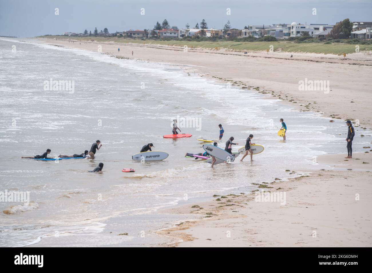 Adelaide, Australia. 22 November 2022.  Young surfers on the beach in Adelaide, South Australia  on a mild sunny day following several days of unsettled weather as temperatures are forecast to rise to mid 20celsius. Credit: amer ghazzal/Alamy Live News Stock Photo