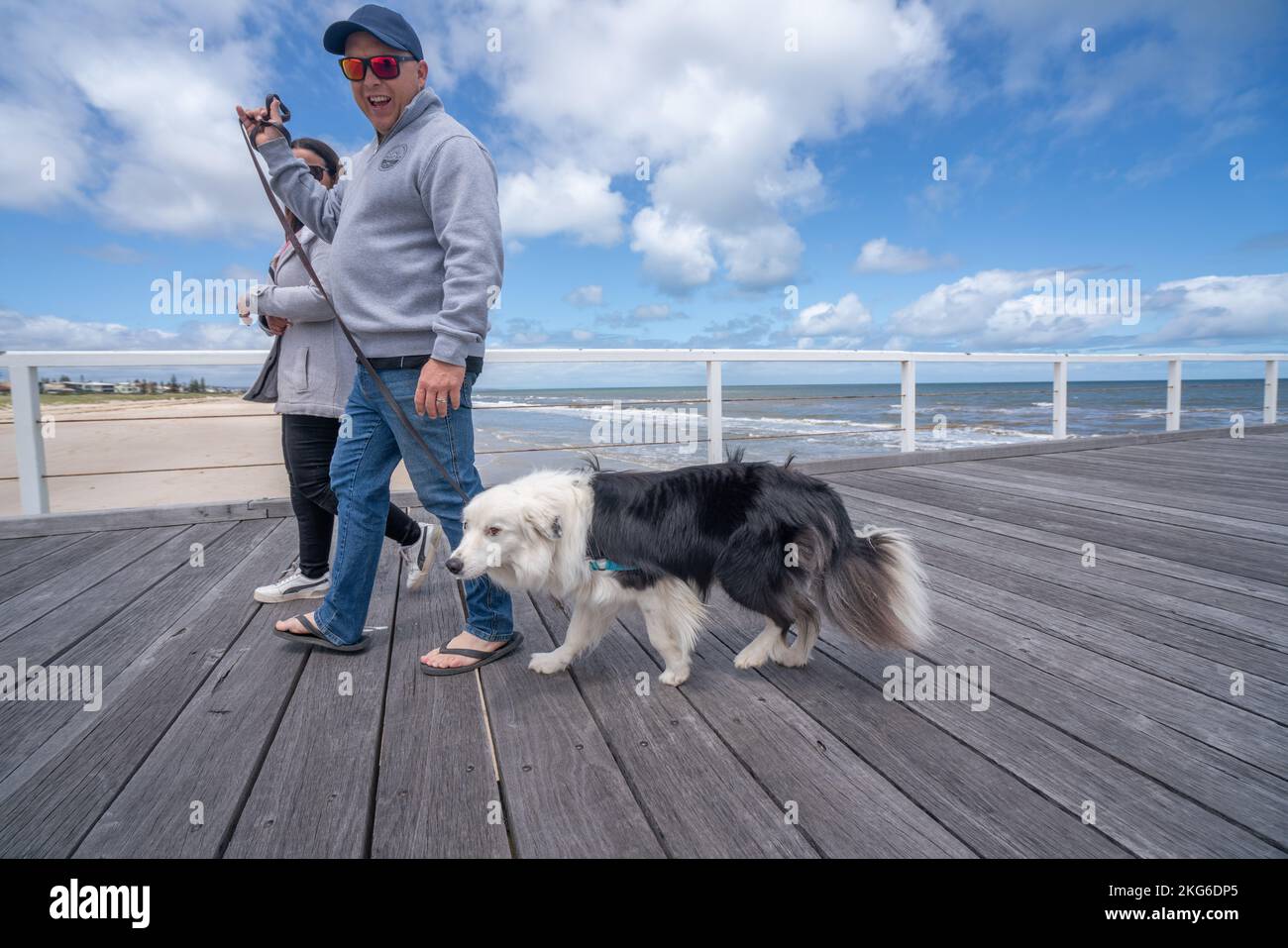 Adelaide, Australia. 22 November 2022. Walkers with a dog on  the jetty pier in Adelaide, South Australia  on a mild sunny day following several days of unsettled weather as temperatures are forecast to rise to mid 20celsius. Credit: amer ghazzal/Alamy Live News Stock Photo