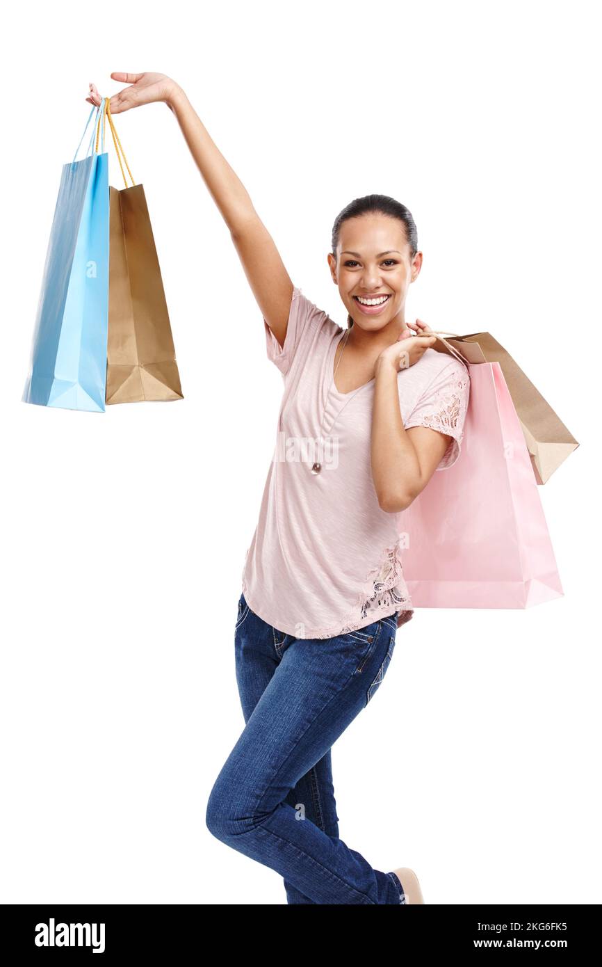 Been on a spending spree. Portrait of an attractive young woman showing off her shopping bags isolated on white. Stock Photo