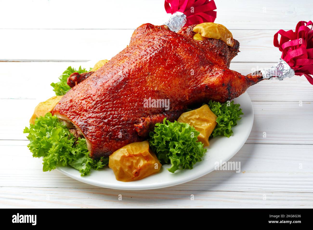 Oven baked duck with herbs and fruits on white plate Stock Photo - Alamy