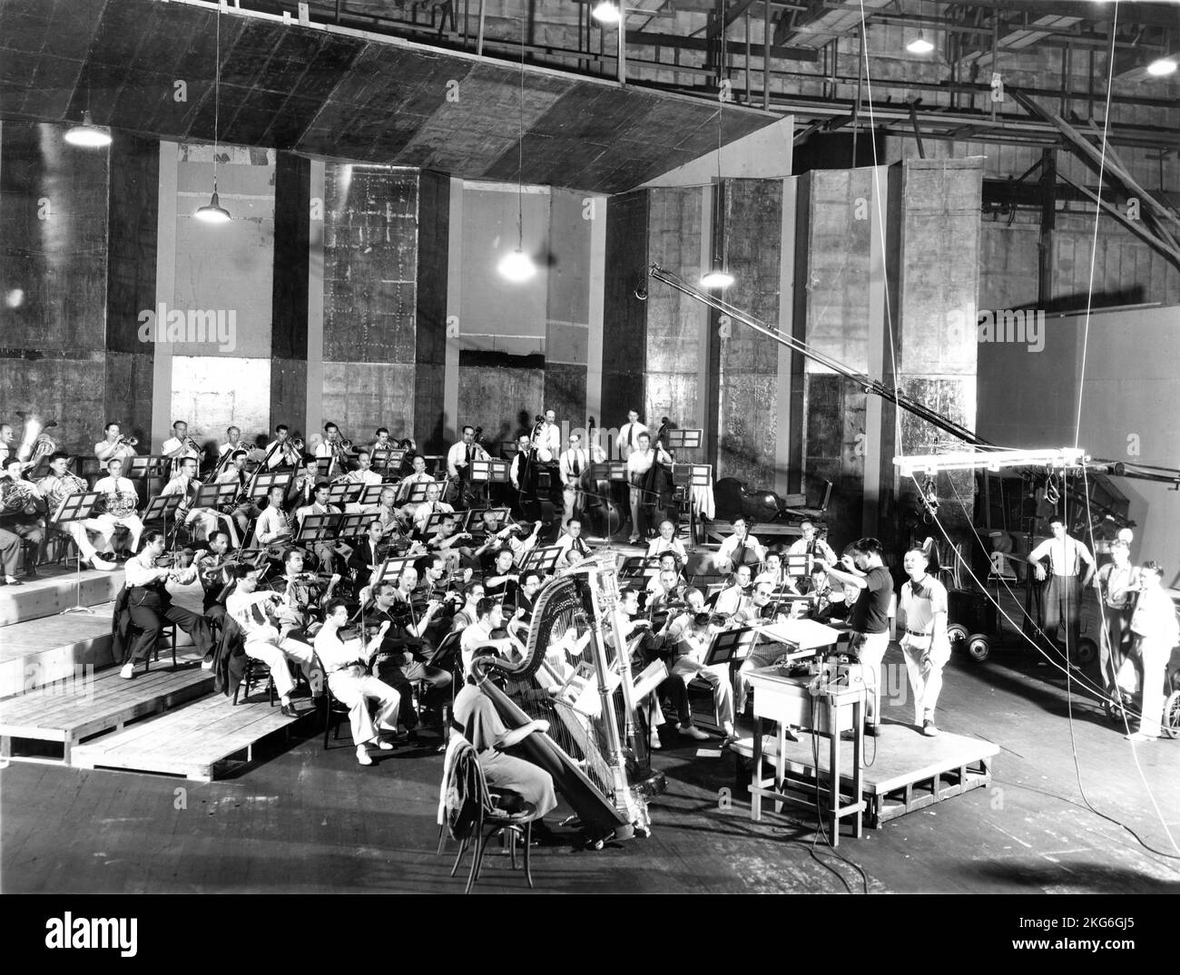 Musical Director ALFRED NEWMAN conducting Orchestra during recording at United Artists Studios of songs sung by Metropolitan Opera Star LAWRENCE TIBBETT (standing to right of Newman) for METROPOLITAN 1935 director RICHARD BOLESLAWSKI producer Darryl F. Zanuck presenter Joseph M. Schenck 20th Century Pictures / Twentieth Century Fox Stock Photo