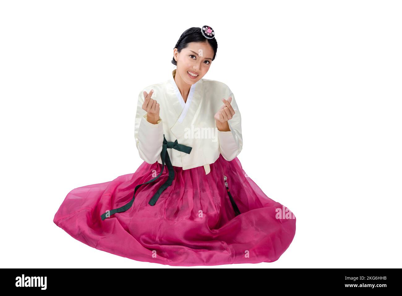 Asian woman wearing a traditional Korean national costume Hanbok sitting isolated over white background Stock Photo Alamy
