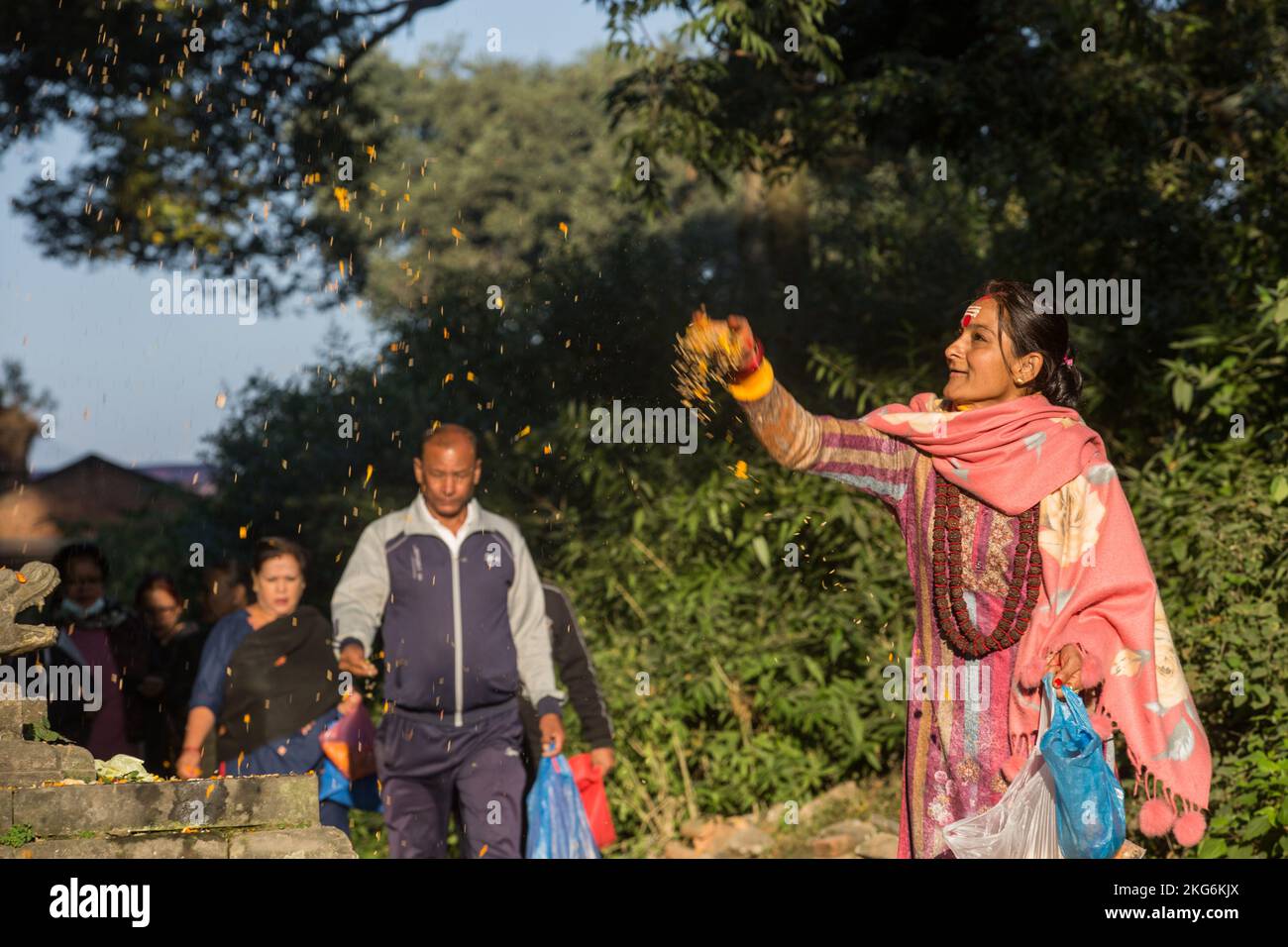 Kathmandu, Nepal. 22nd Nov, 2022. People scatter a mixture of seven