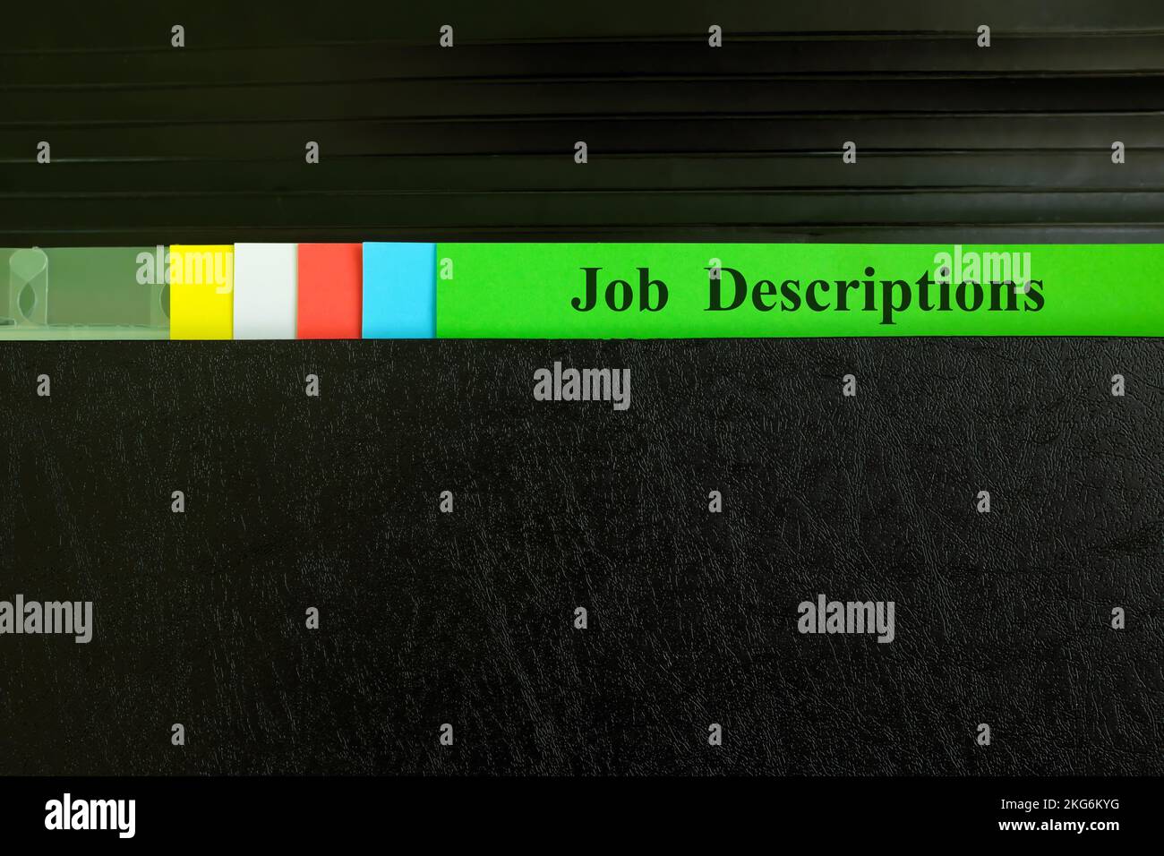Hand picking job description file in black binder folder. Human resources concept Stock Photo