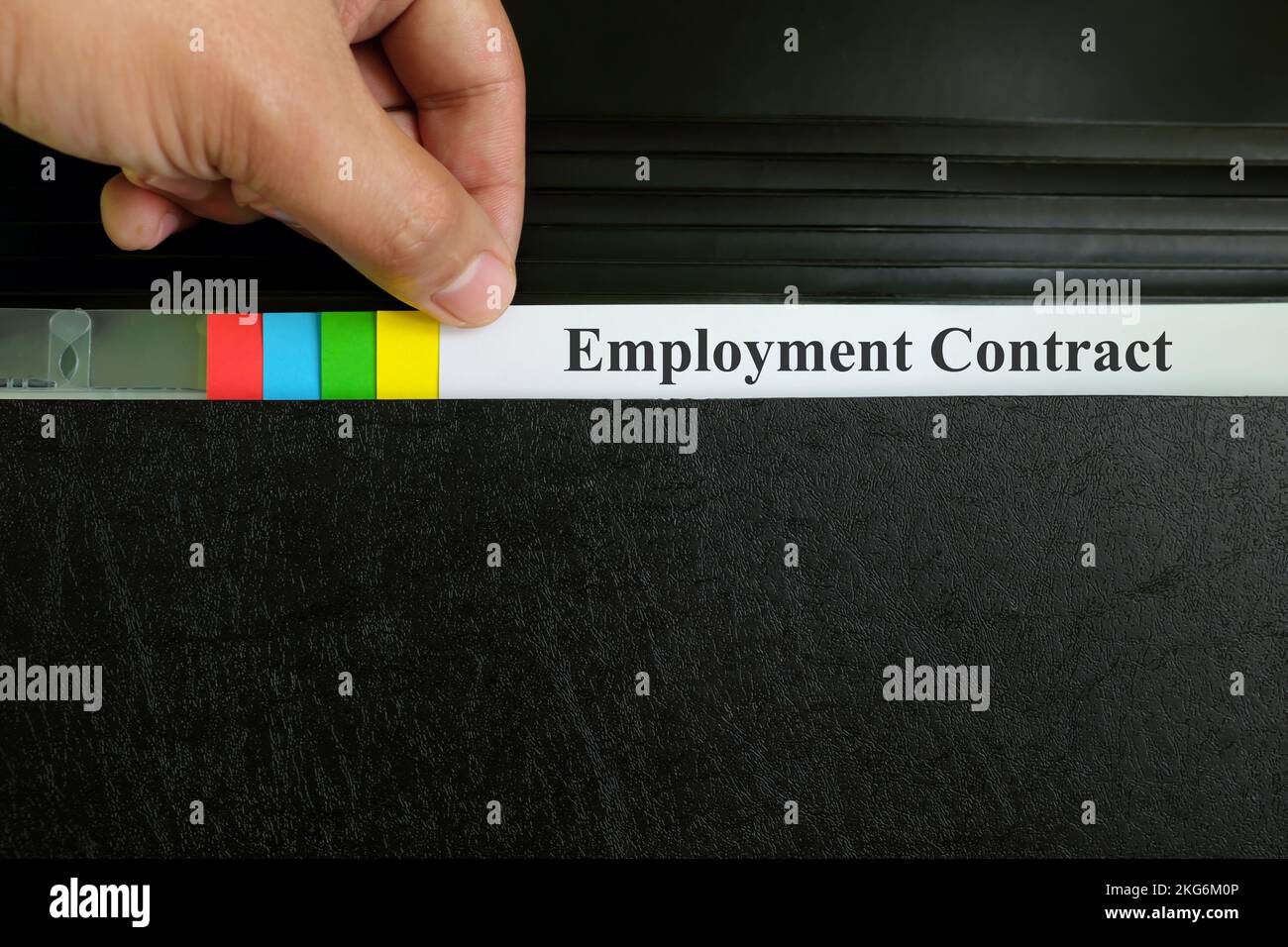 Employment contract file in black binder folder. Human resources