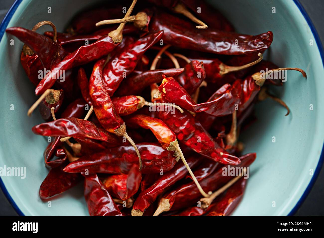 Time for a good old chili con carne. High angle shot of dried red chillies in a bowl on a kitchen counter. Stock Photo