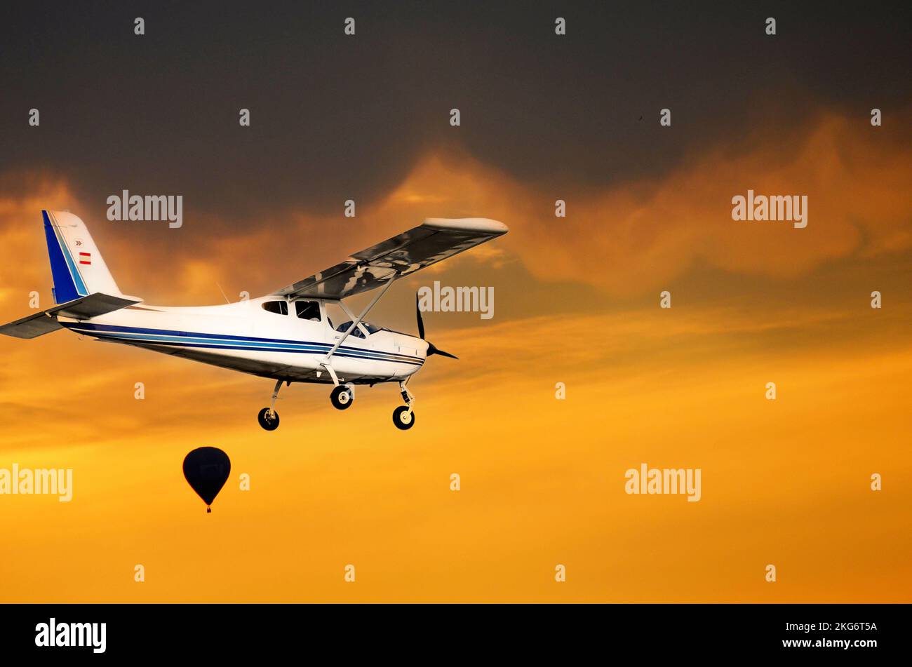 Beautiful shot of a single engine ultralight aircraft flying under the sunset sky Stock Photo