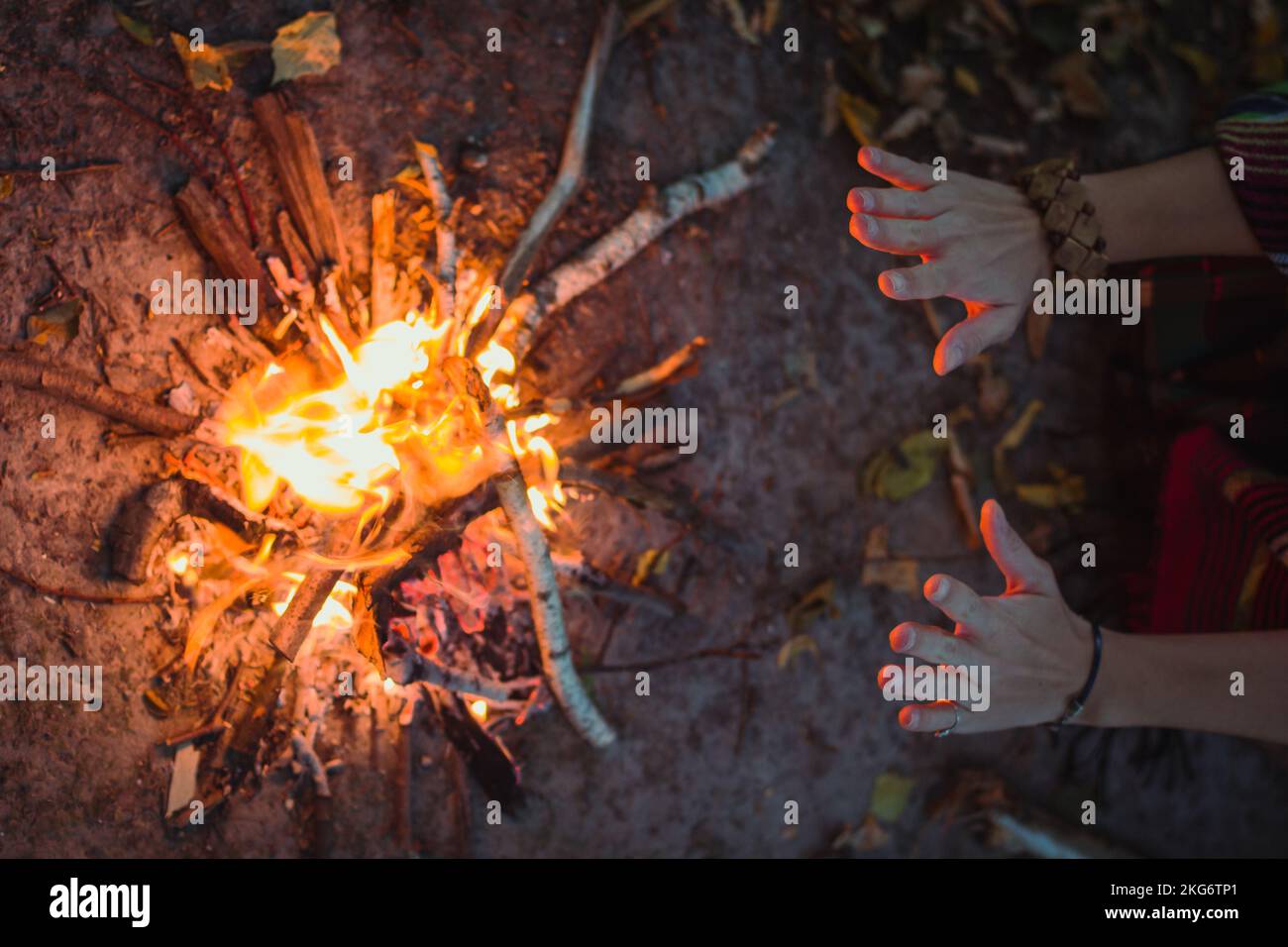 Close up hands over campfire concept photo Stock Photo Alamy