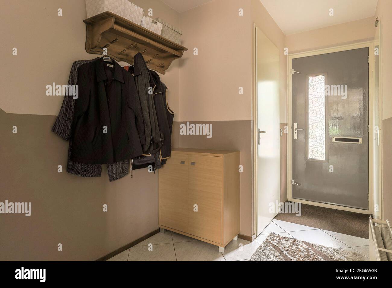 View of Narrow corridor with doors leading to spacious room in urban apartment ...
