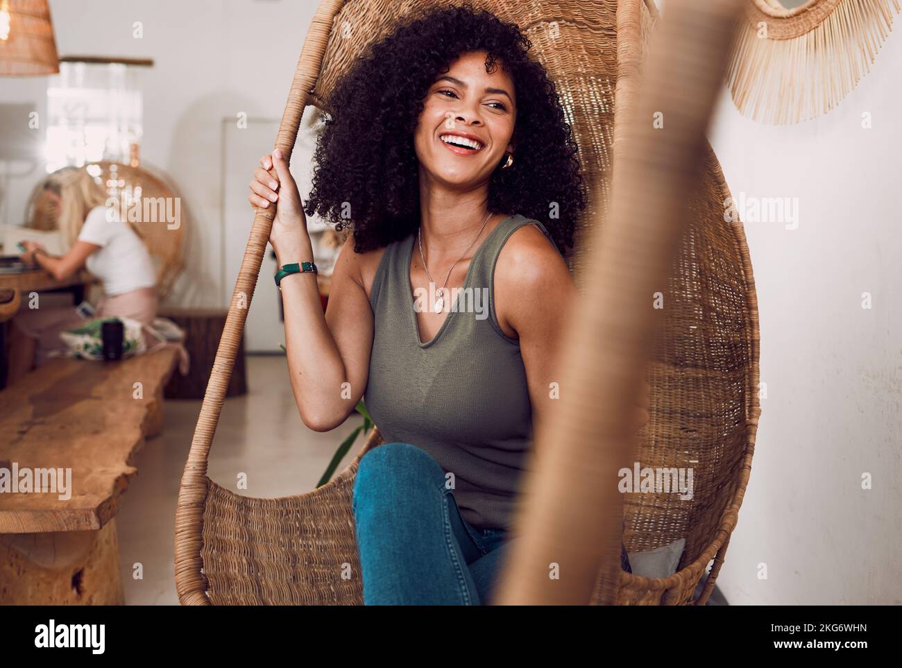 Black woman, happy smile and sitting in chair, coffee shop and freedom, afro and relax with positive mindset. Gen z girl, cafe and happiness, weekend Stock Photo