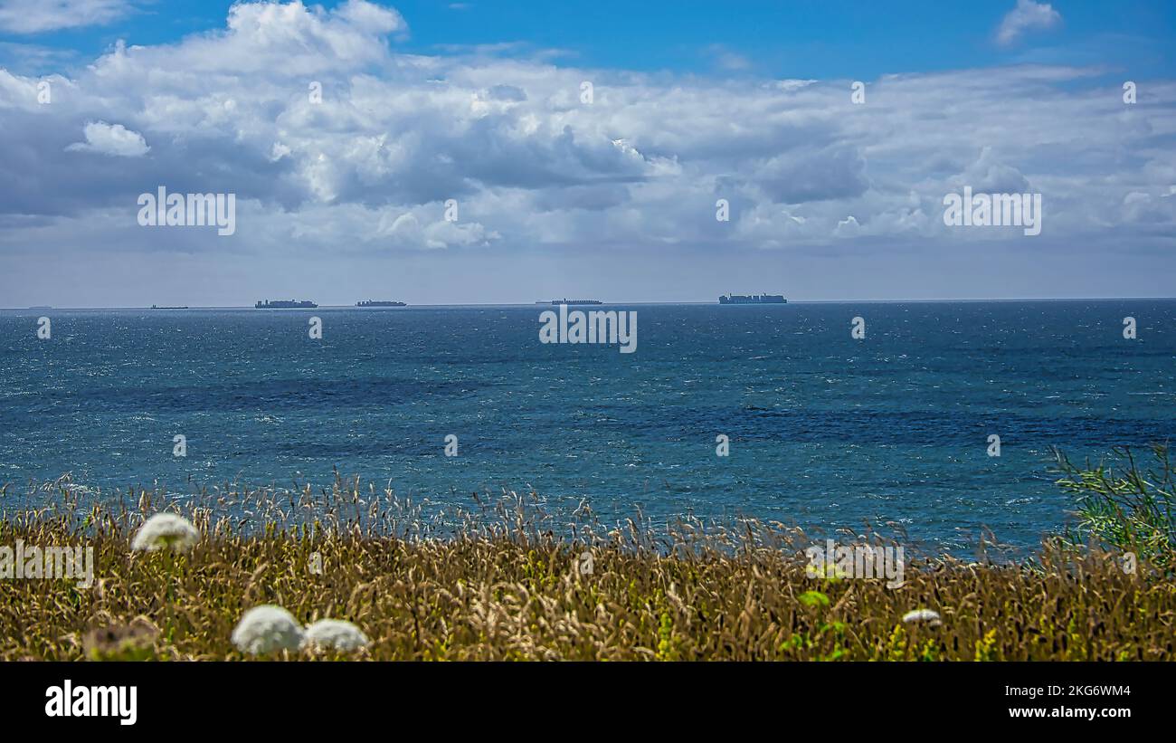 A scenic view of the calm sea under the cloudy sky Stock Photo - Alamy