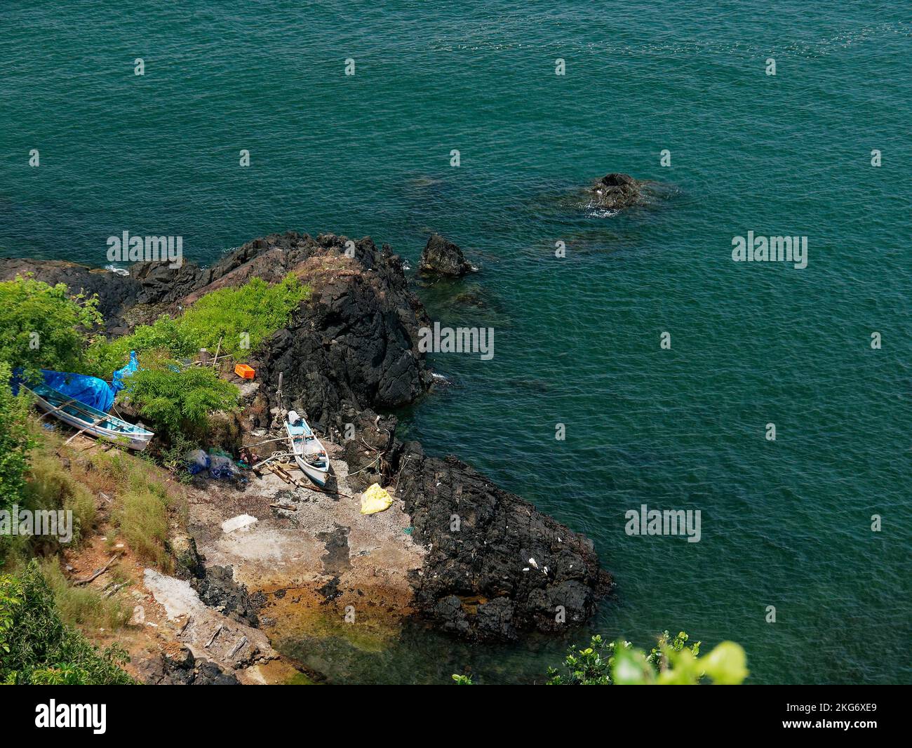 Fishing boats parked on the rocks of seashore of Cabo de Rama Fort in Goa India 10 14 2022 Stock Photo