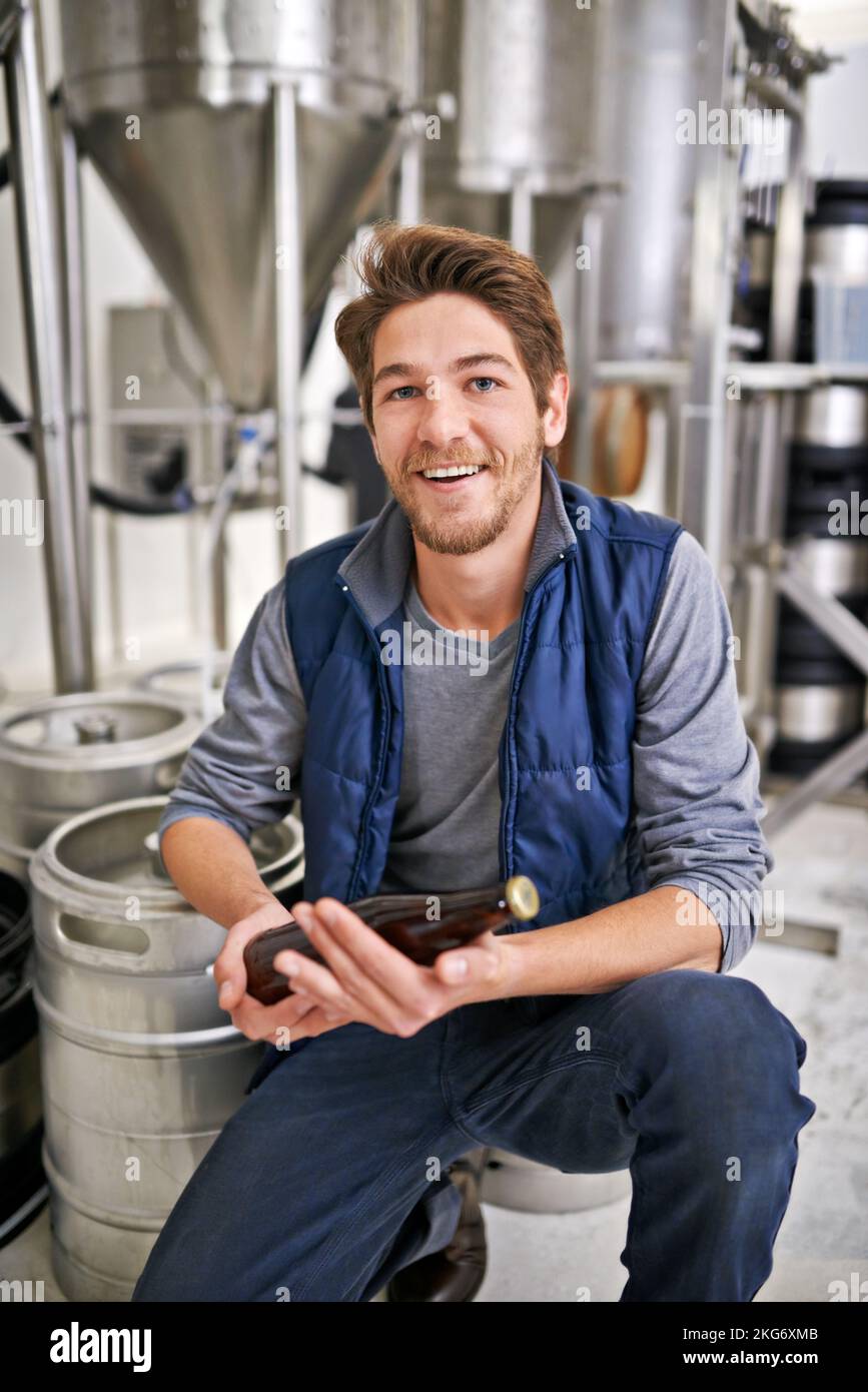My finest brew yet. Portrait of a happy young man working in a brewery. Stock Photo