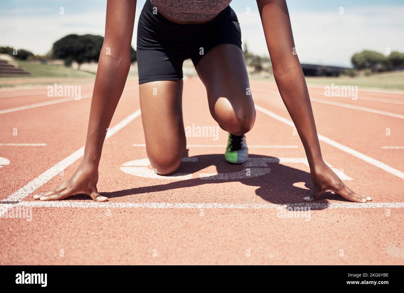 Start running and sports with black woman on stadium ground for training, stamina and workout. Strong, energy and stamina with runner and ready for Stock Photo