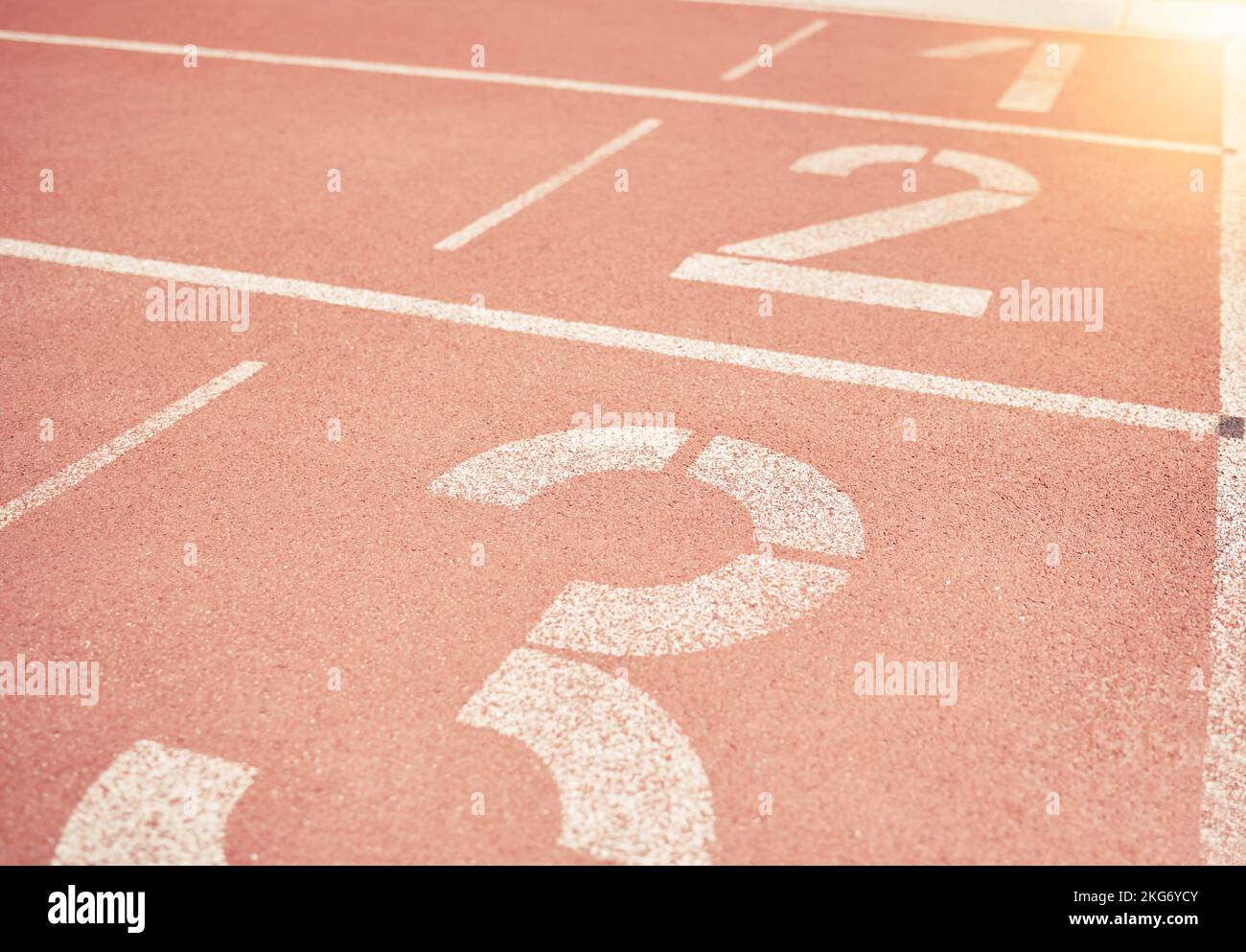 Sports, athletics and number on race track in stadium for training, sprint and running start position. Texture, ground and running track with nobody Stock Photo