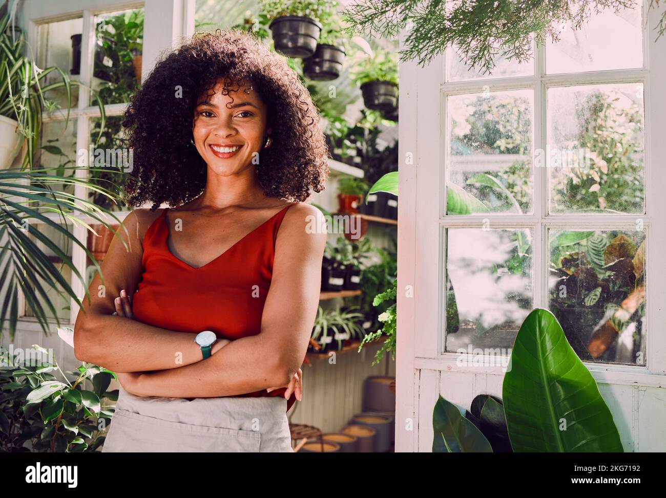 Black woman, arms crossed or plant shop worker and agriculture knowledge, carbon footprint innovation or growth ideas. Portrait, smile or happy Stock Photo