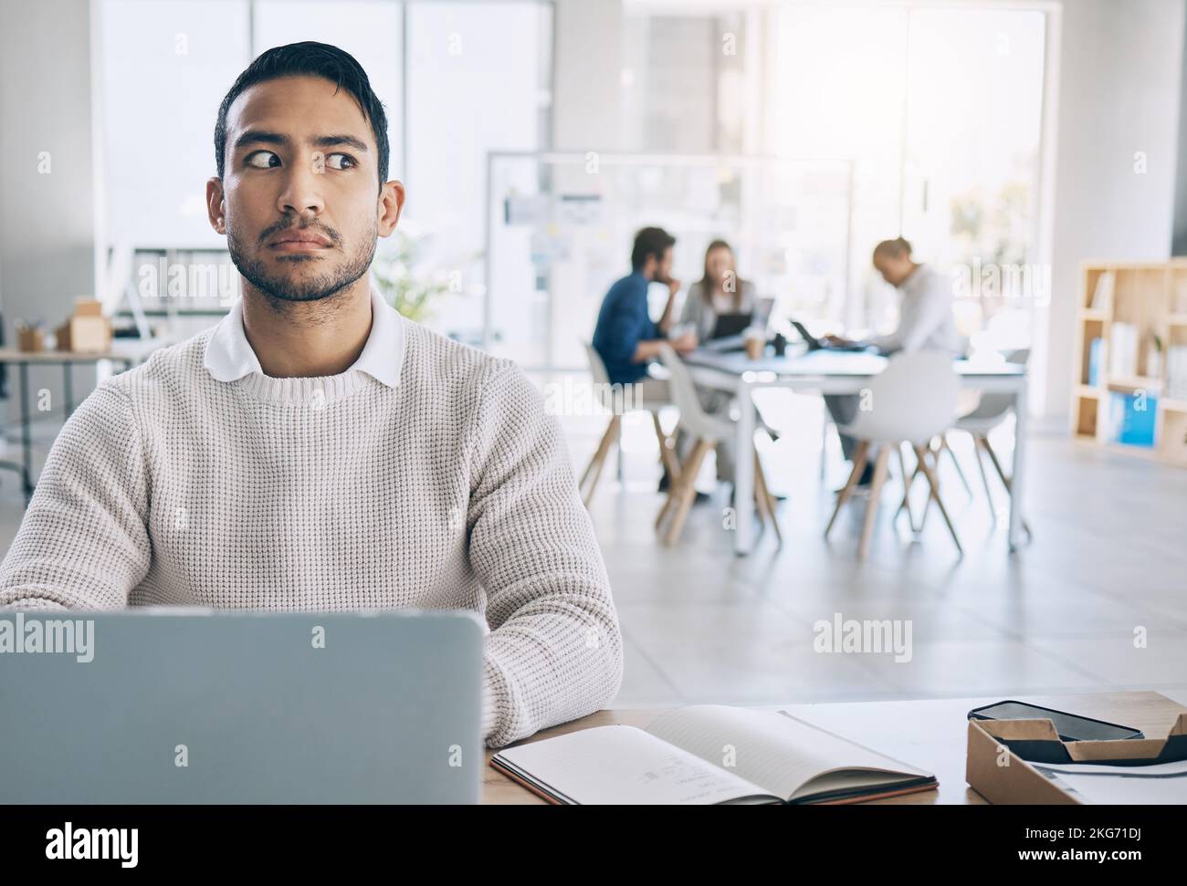 Businessman, suspicious and listening to gossip, conversation and awareness in with laptop in office. Corporate worker, scandal and shock, listen or Stock Photo