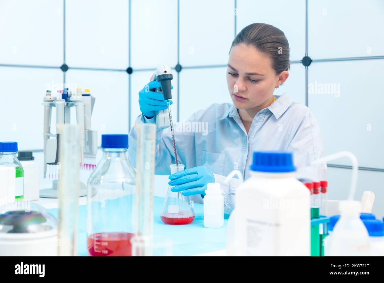 female laboratory assistant in microbiology laboratory use centrifuge ...
