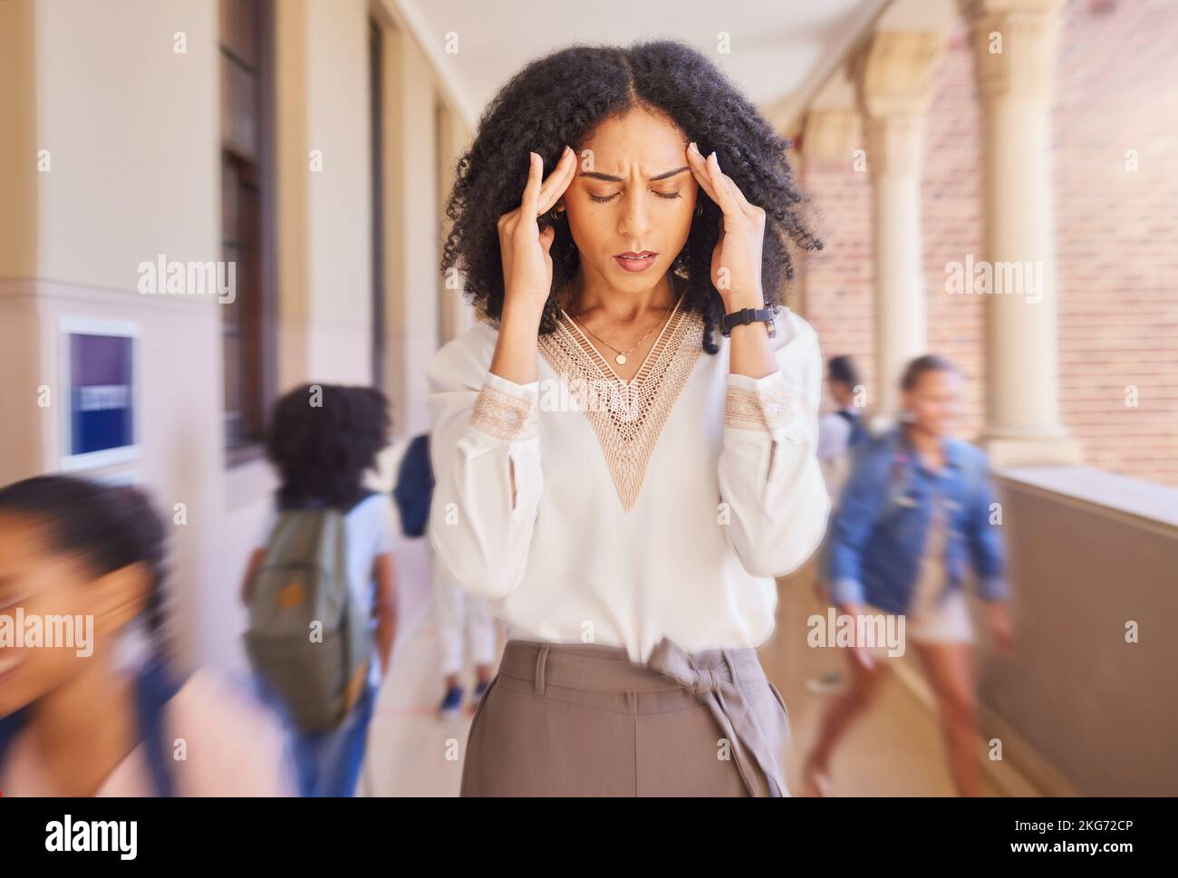 Headache, tired and stress teacher in school with fast children thinking of work stress, education mindset and management challenge in hall. Black Stock Photo