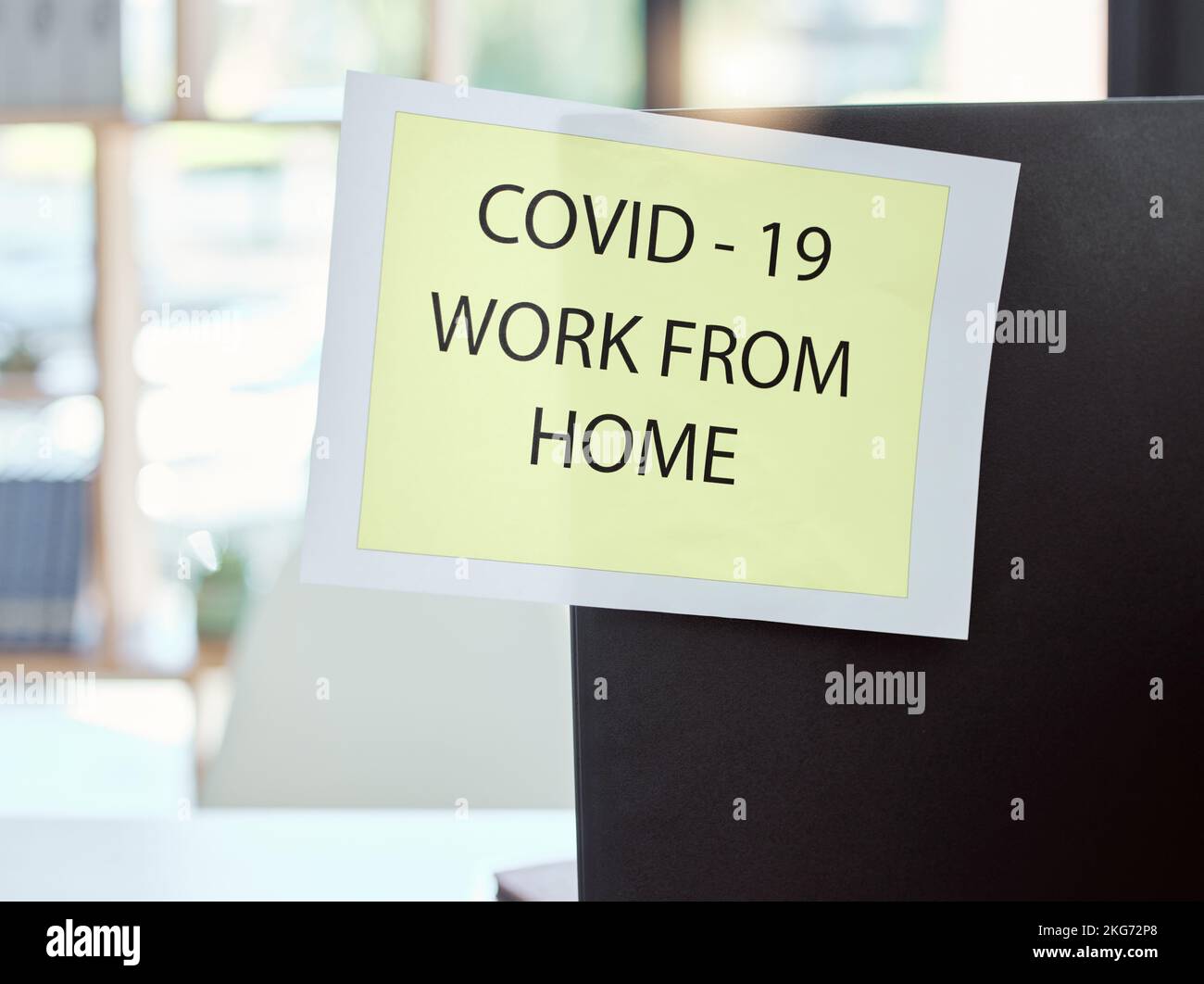 Covid, sign and work from home at the office for health and safety rules or regulations during pandemic. Label post of corona virus restrictions for Stock Photo