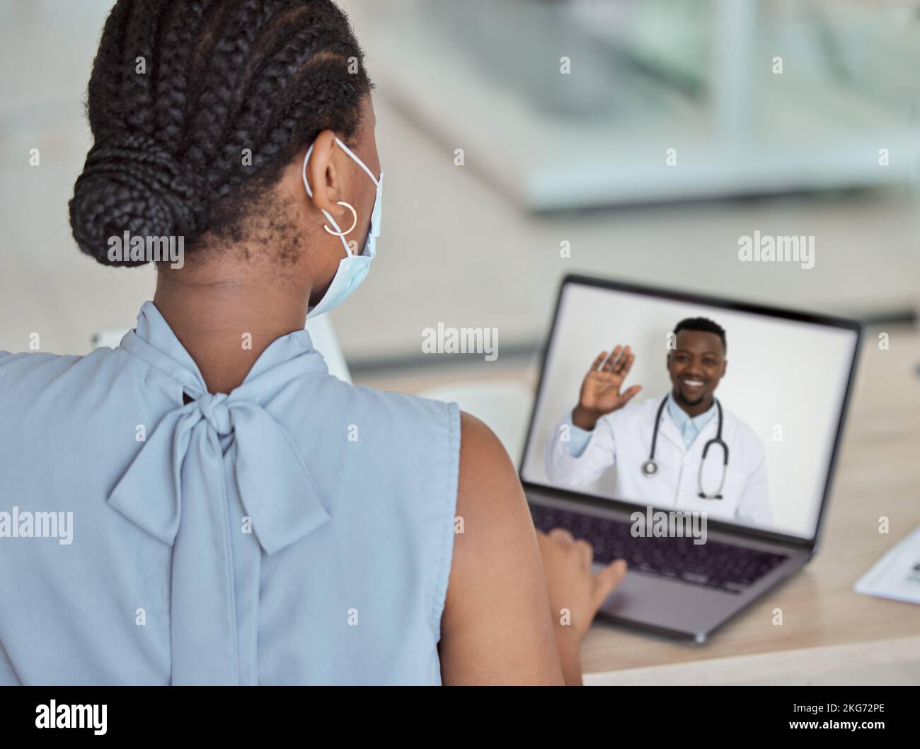 Covid, laptop and remote consultant with a doctor black man on a computer screen talking to a patient. Meeting, health and medicine with a woman on a Stock Photo