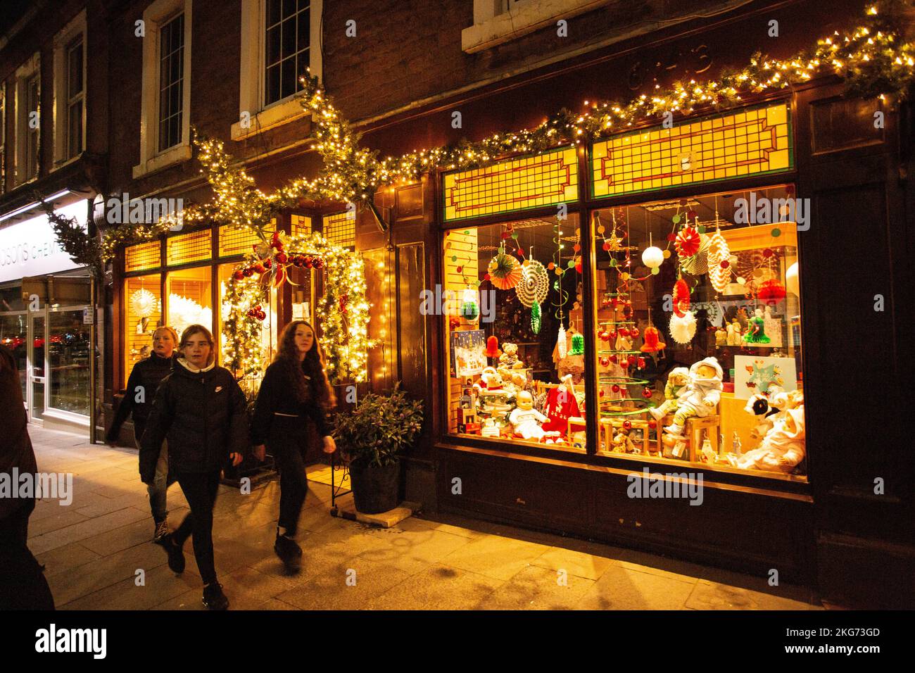 Christmas decorated shop front independant retailer with shoppers on