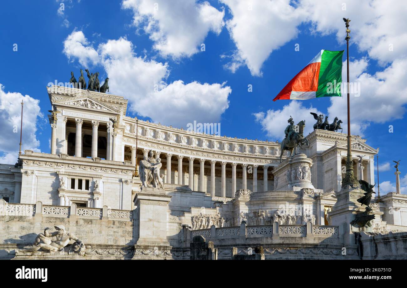 Beautiful view of a Vittoriano - monument in honor of Victor Emmanuel II with a flag of Italy against a blue sky in the sunny day. Rome, Italy Stock Photo