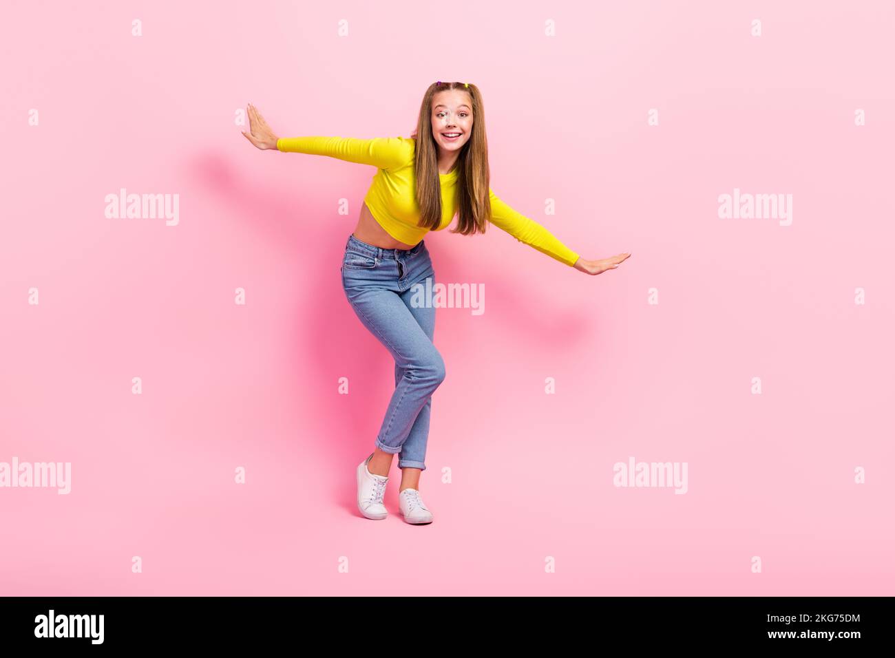 Full length photo of excited dreamy school girl dressed yellow crop top