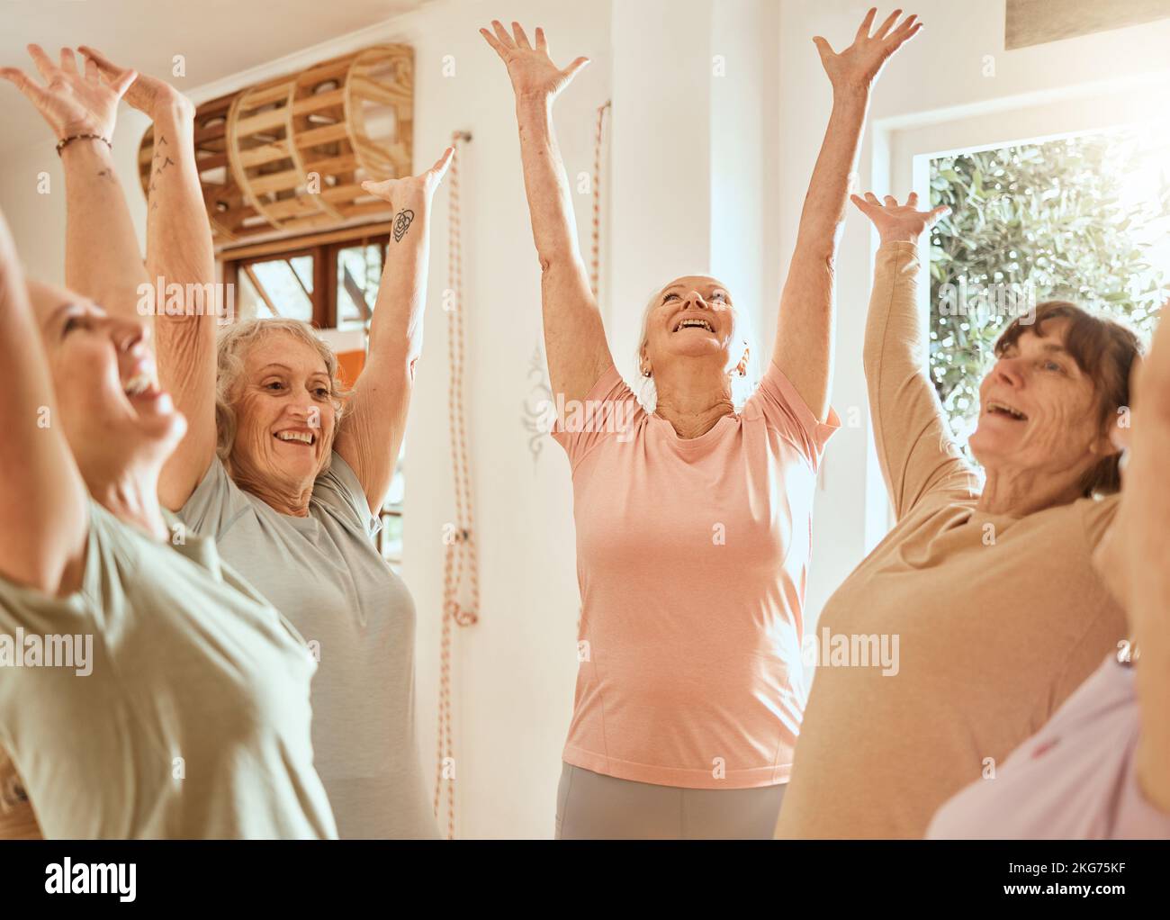 Fitness, success and senior women with their hands up in celebration after yoga or pilates training class. Smile, teamwork and happy elderly friends Stock Photo