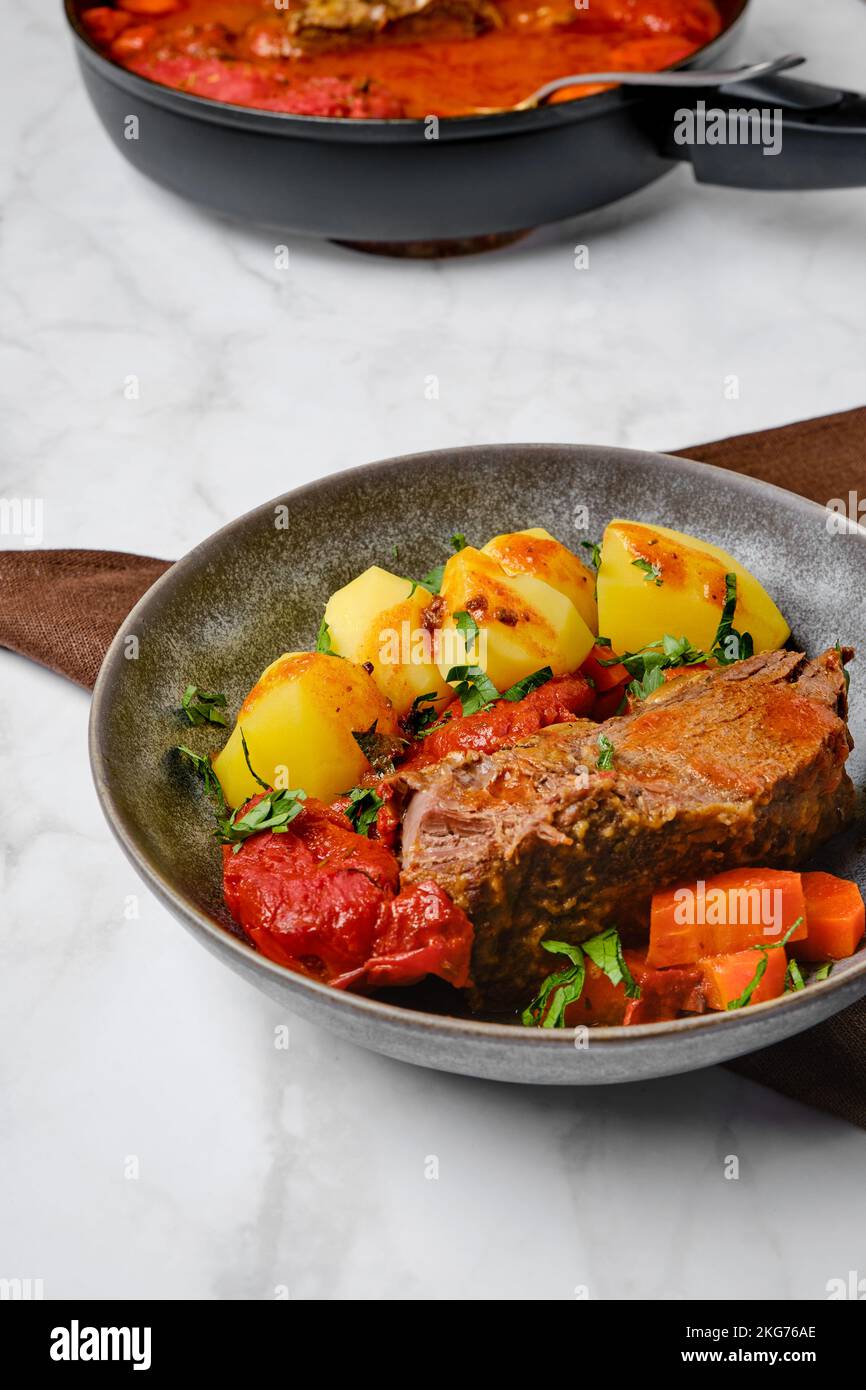 Slow cooking food. Bottom round roast beef meat baked in beer gravy