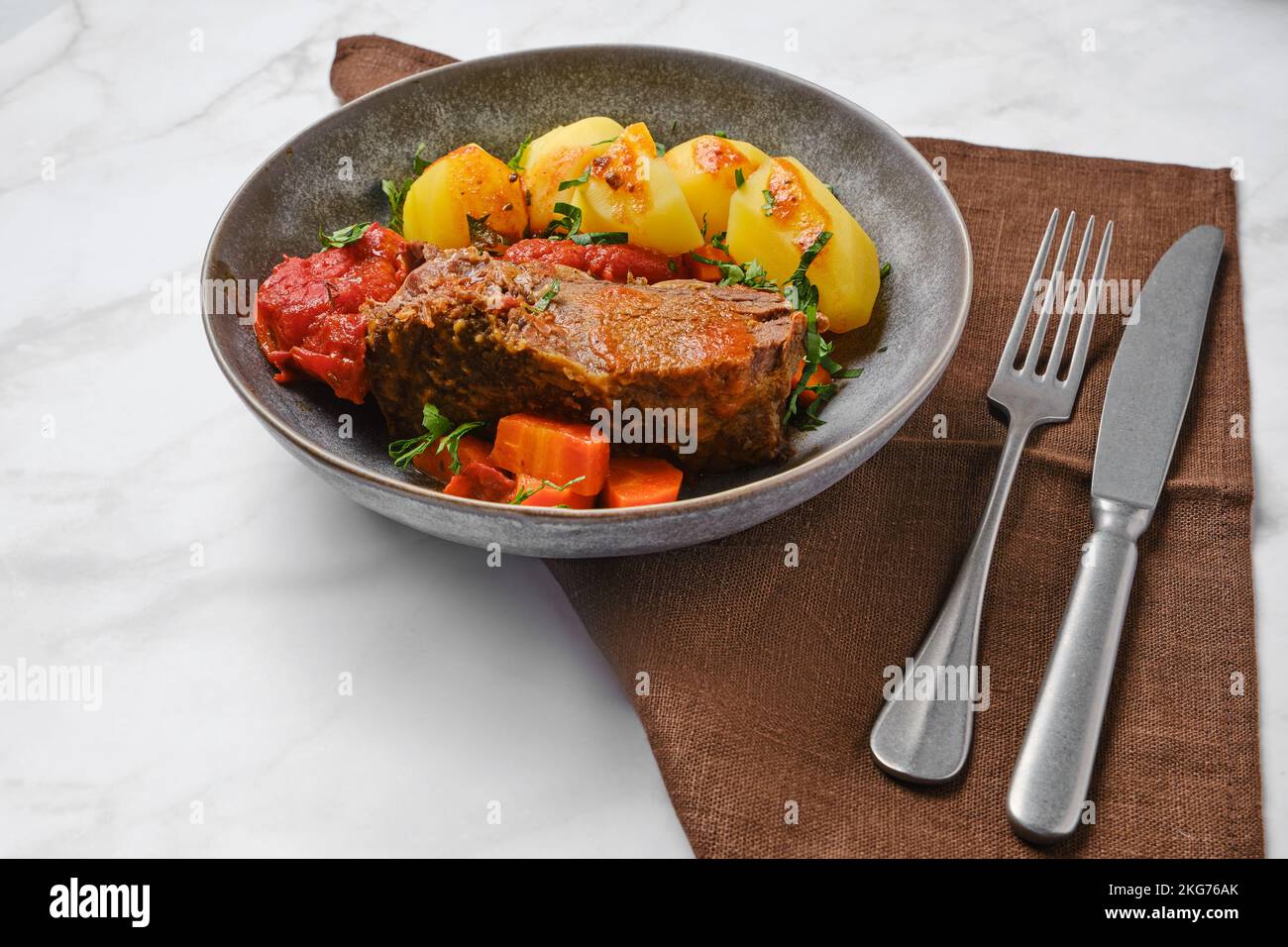 Slow cooking food. Bottom round roast beef meat braised in beer gravy