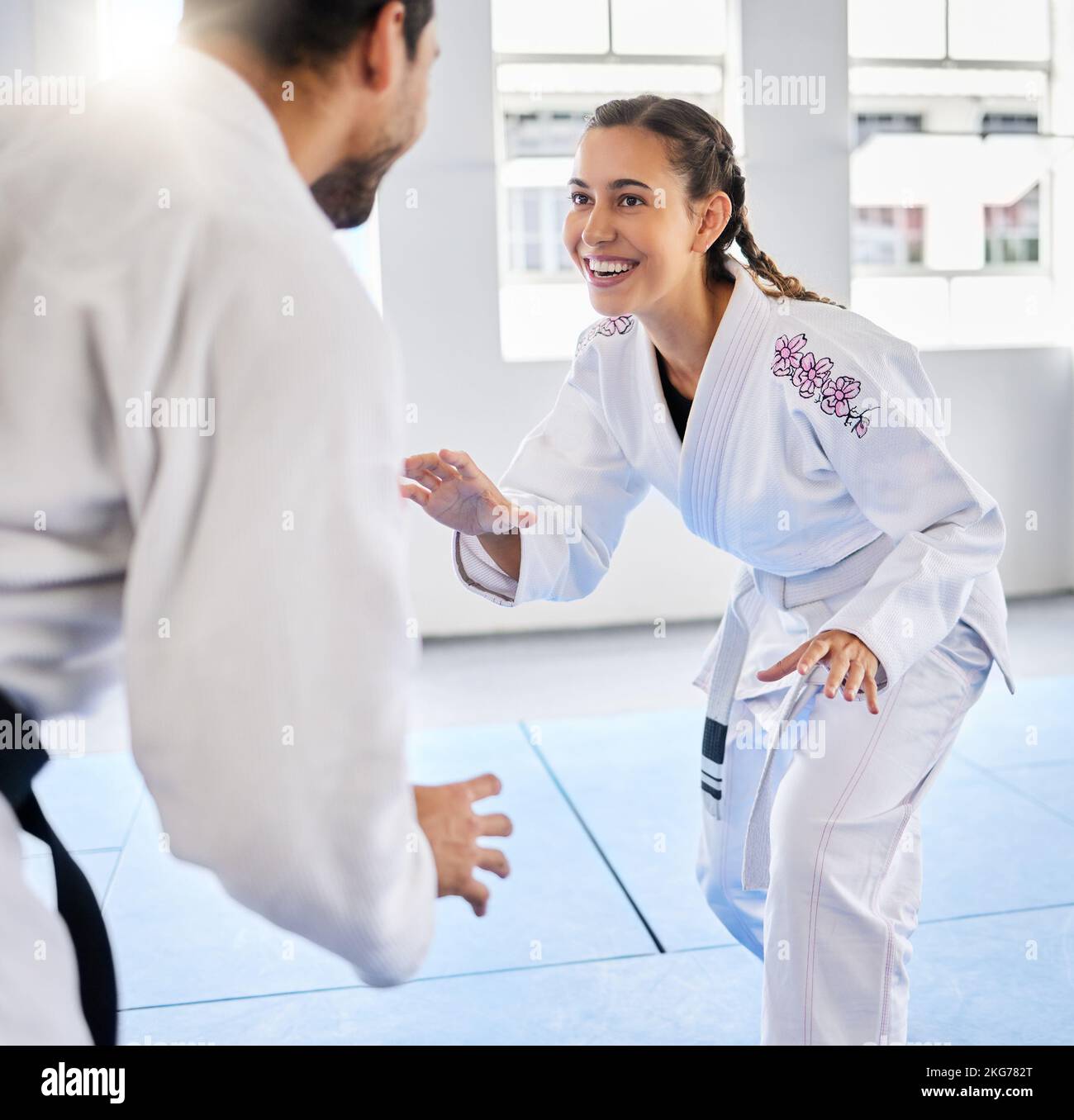 Karate, fitness and teacher with student, combat sports and training for skill development, power and discipline in dojo gym. Fight, happy in Stock Photo