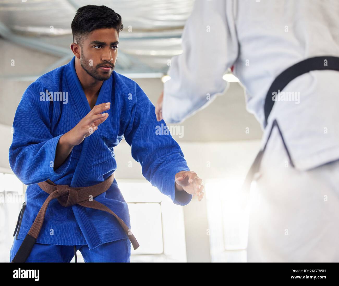 Martial arts, karate and student learning safety or self defense from a taekwondo expert or master in a dojo. Focus, fitness and fighting instructor Stock Photo