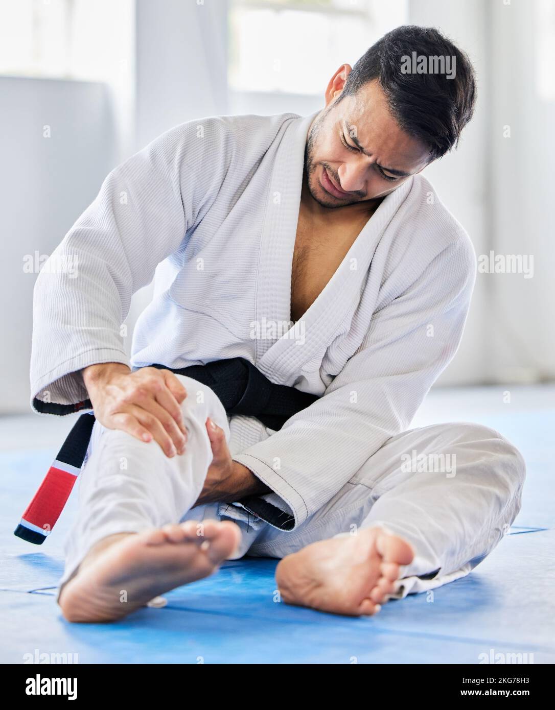 Injury, karate and man with knee pain after an accident in martial arts