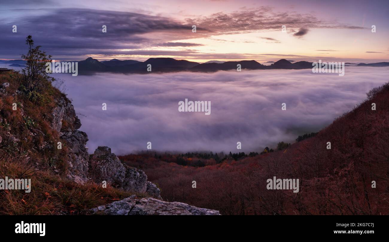 Dramatic autumn sunrise in mountain with red sky and clouds Stock Photo